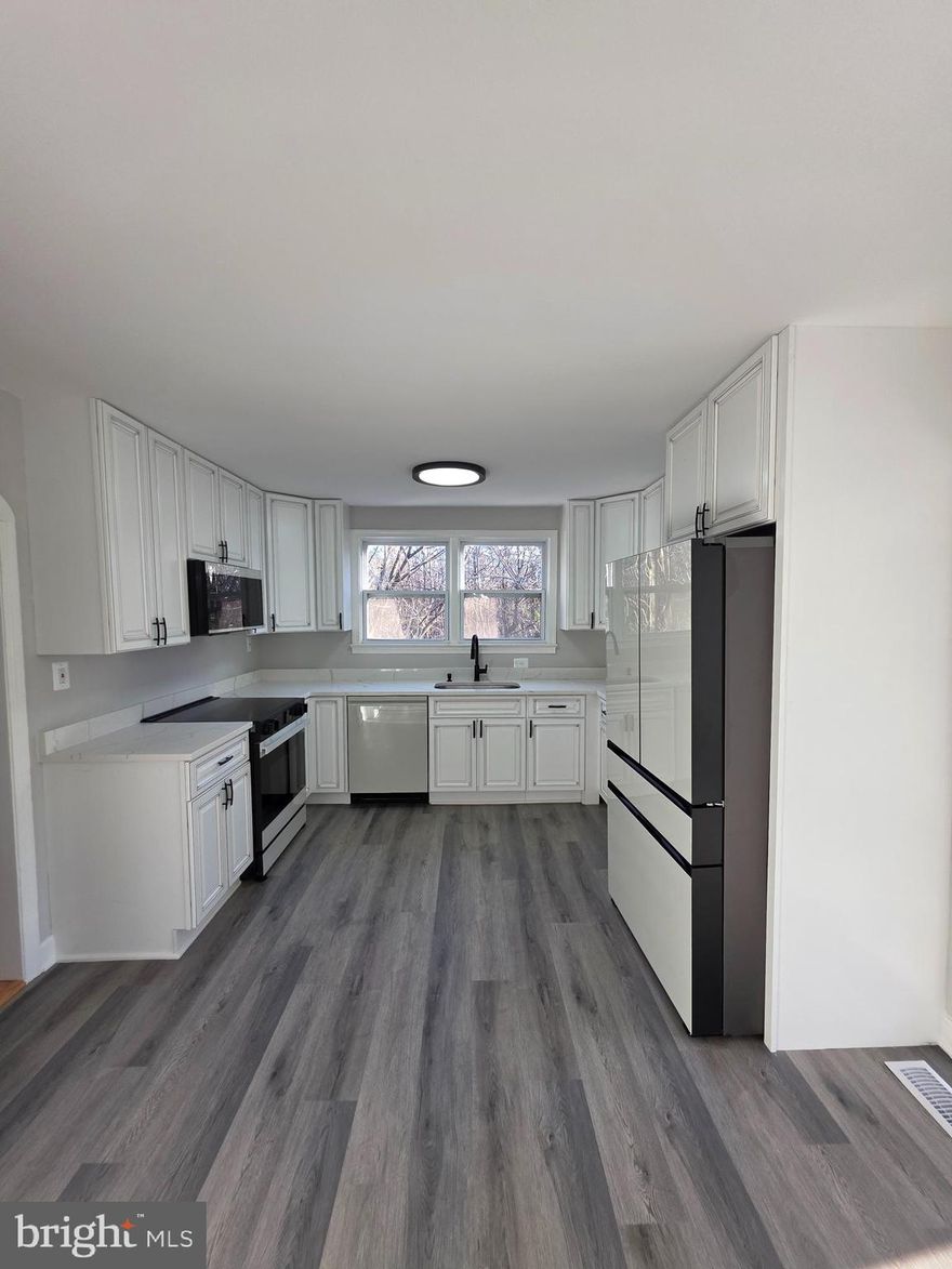 Completely renovated. Better than new. New custom ceramic tile work in bathrooms by Santos. Kitchen has new Sunny wood cabinets. New quartz Calcutta Gray counter tops. Kitchen has stainless steel  Samsung Bespoke appliances: slide in range, French door refrigerator with dual ice and water, slide in range, built in microwave and wine cooler New large Trex deck off kitchen. New red oak hardwood floor on main level. New carpet in bedrooms. New vinyl plank flooring on lower live and enclosed porch. New plumbing fixtures throughout. Over 3 acres, detached garage and carports.