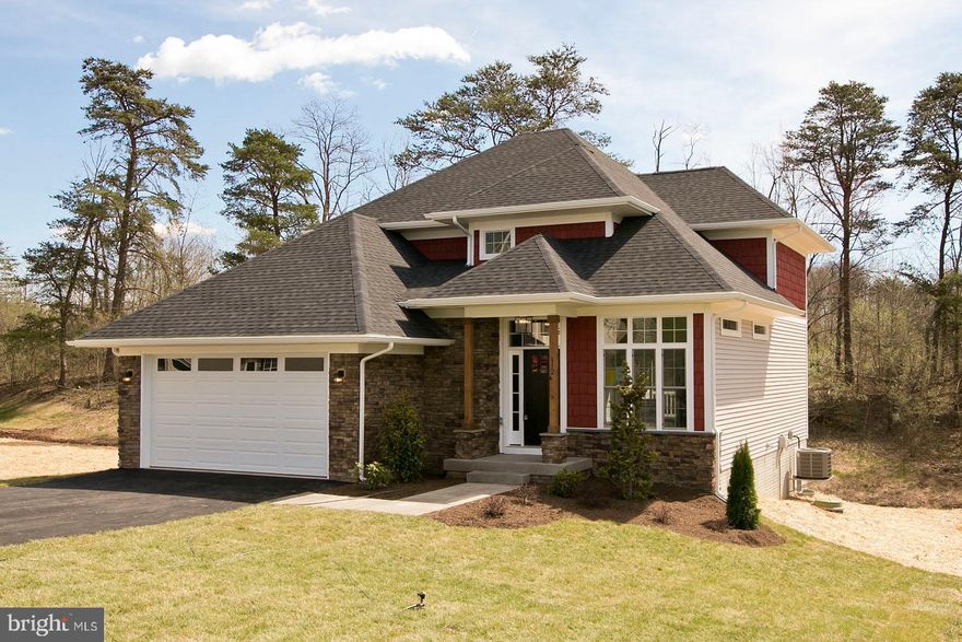 Beautiful NEW CONSTRUCTION - just completed! Don't miss this immaculate Craftsman style home with so many upgrades you'll never feel right about the finishes in another home! This custom builder has put his heart and soul into this home and it shows. Wide open floor plan for entertaining in your gorgeous kitchen with quartz counters, herringbone backsplash, wide plank floors, custom lighting and a custom stair railing you won't believe! No detail has been left untouched! Wet weather stream greets you off your deck, with plenty more space in the woods behind you to expand your outdoor living space. The lot backs to community property so you'll have tons of privacy and easy access to the old golf course for walking pets or exploring. Main level master bedroom, bath and laundry makes one level living a possibility while having three more bedrooms upstairs for guests and a HUGE finished basement for that game room, craft area or man cave you've been dreaming about! Close to the gate for easy commuting, don't let this one pass you by, schedule your viewing today and make an offer!