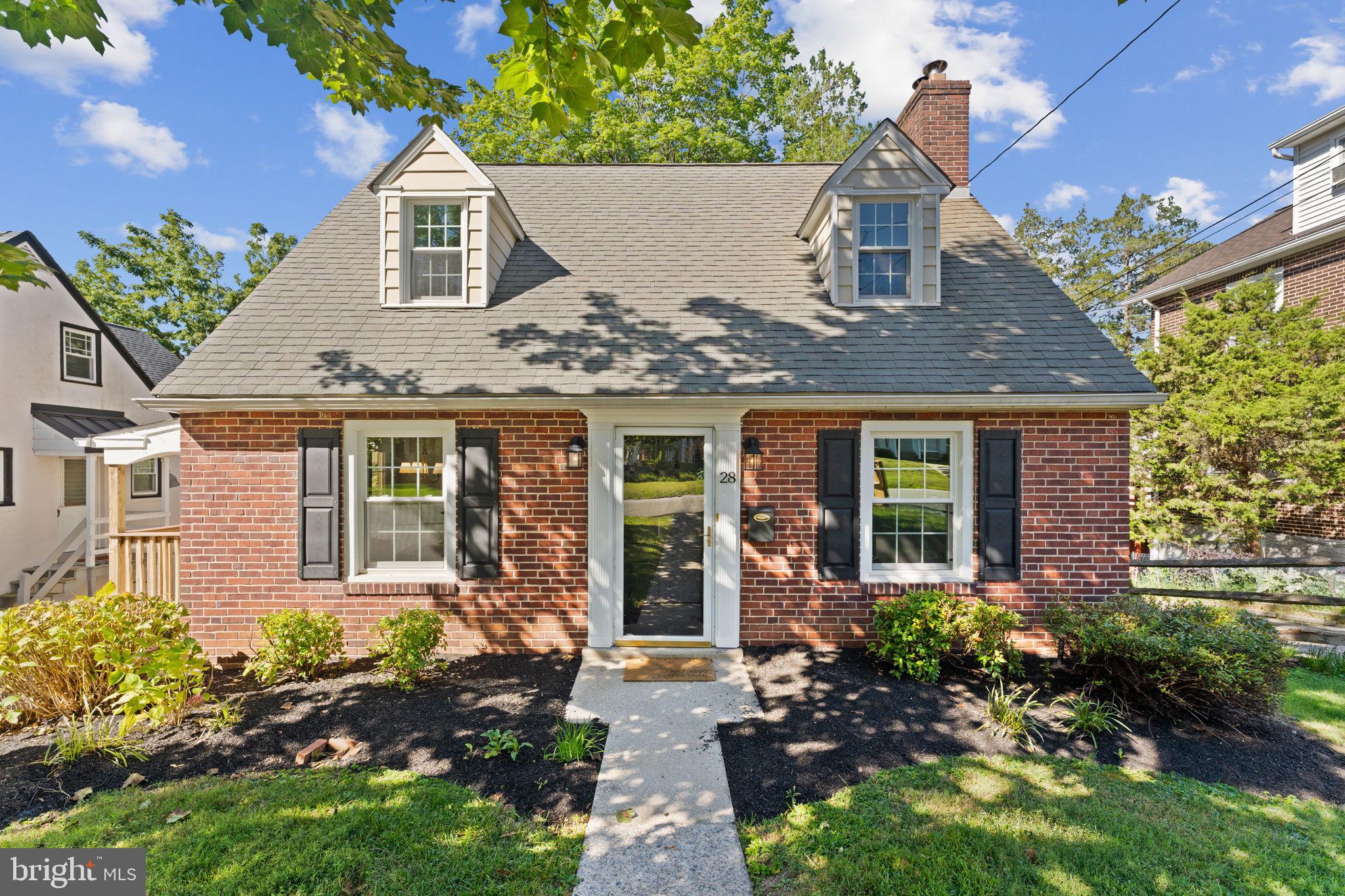Welcome to 28 Manor Road, a charming brick Cape Cod home located in the heart of Paoli and within the award-winning Great Valley School District. This 3-bedroom + office or nursery, 2-bathroom home combines classic character with modern updates, offering a warm and inviting space for everyday living. Step inside to a bright living room featuring hardwood floors, fresh paint, and a cozy fireplace. The charming dining area has a cute window seat and additional cabinetry for storage. Moving into the updated kitchen boasting granite countertops, wood cabinetry, and newer appliances plus easy access to the deck and backyard. The first floor also includes one bedroom and a full bathroom with pedestal sink and tub/shower. Upstairs, 2 additional spacious bedrooms provide sunny retreats, while the second full bathroom is neat, clean and stylishly finished. There is a bonus room on the second floor that could be a nice private home office, optional 4th bedroom or a nursery. The full, unfinished, walk-out basement offers excellent storage and laundry space with plenty of potential for future customization. Outdoors, enjoy the expansive backyard shaded by mature trees—perfect for play, gardening, or relaxation. The composite deck extends the living space, creating a great spot for outdoor dining and gatherings. Being situated just minutes from both Paoli and Malvern allows you to enjoy the local shops and dining. This home provides easy access to major routes and public transportation for a convenient commute to Philadelphia or New York. With its blend of charm, functionality, and location, 28 Manor Road is ready to welcome its next owners!
