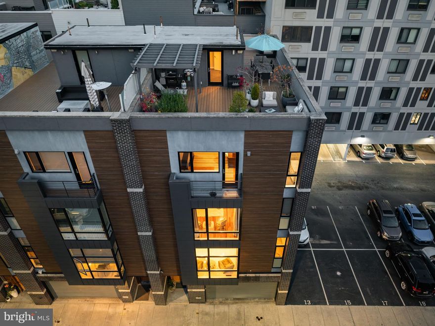 Discover an extraordinary end-unit custom townhome, exceptional in size at 28 feet wide and 58 feet long, offering over 4,700 square feet of unmatched luxury and comfort. This unique gem is located in the Greenfield School District and features two remarkable outdoor spaces, perfect for hosting unforgettable gatherings. With 10-foot ceilings and abundant natural light, the home is nestled on a peaceful dead-end street within the Logan Square neighborhood, just a 10-minute stroll from the vibrant Rittenhouse Square and the scenic Schuylkill River Trail, close to museums, local grocery stores, and charming neighborhood spots.

Experience exceptional living in this remarkable residence, which includes a two-car garage and a custom five-stop elevator for ultimate convenience. A stunning floating staircase connects all five levels, featuring five spacious bedrooms, 4.5 baths, and expansive living and dining areas seamlessly transitioning to beautiful outdoor spaces enhanced by a whole-house Sonos system. This home radiates serenity and joy, providing incredible opportunities for relaxation and entertainment by the fireplace.

The state-of-the-art kitchen is a culinary oasis, showcasing rare European cabinetry and top-of-the-line appliances. A gorgeous deck offers breathtaking views of the Philadelphia skyline. The primary suite, occupying the entire third floor, is a sanctuary of comfort, complete with a generous sitting room/office, ample closet space, and a lavish bathroom featuring a soaking tub and walk-in shower.

On the fourth level, a family lounge/playroom separates two bedrooms with full baths, and an oversized laundry area creates an atmosphere of ease. Ascend to the Pilot House, which is equipped with a mini kitchen that includes a full-size refrigerator, dishwasher, storage, sink, and a powder room. This leads to an expansive, recently renovated, zero-maintenance roof deck. This inspiring space features a second grilling area, a pergola, and a grand dining area, all offering stunning views of the Philadelphia skyline.

From the exquisitely signature interior concept to the captivating outdoor spaces, this end-unit townhouse embodies urban sophistication and elegance. It delivers a truly extraordinary living experience in a serene and convenient setting. This property also comes with a 10-year new stucco warranty.