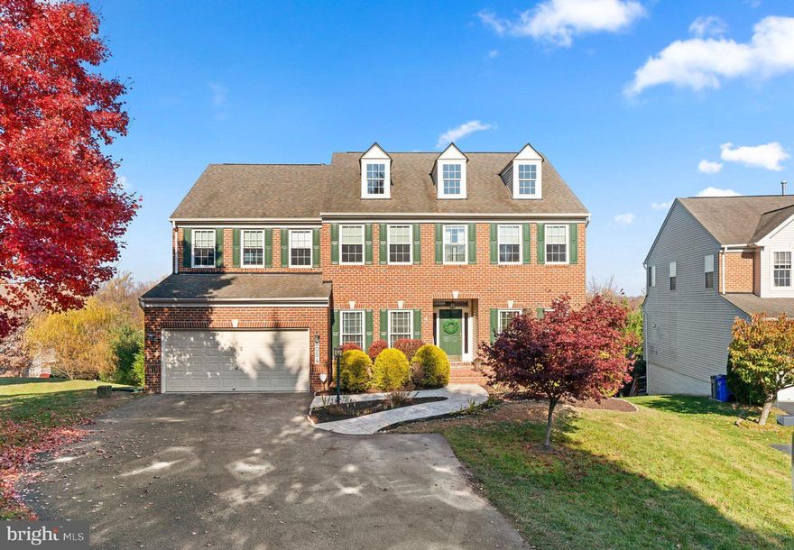 With its stylish sophistication and private .28 acre setting, this brick front modern colonial offers a beautifully landscape yard, and exceptional spaces for living, entertaining, and outdoor leisure activities in sought-after Taylor Village’s Autumn View.  Designed to create an entirely new aesthetic, this home features gleaming hardwoods, profile moldings and trim, an inviting foyer from which you discover a timeless interior showing a formal living room, a formal dining room accentuated by chair rail and picture frame trim, large profile crown moldings, and a private yet accessible study.  At the end of the foyer is the quintessential family room adorned with a breezy ceiling fan for added comfort and a cozy stacked stone fireplace topped with a crisp white mantel and a surround of windows.  Made for entertaining, the open gourmet kitchen features a center island with breakfast bar, 42” crown trimmed raised panel maple cabinetry, sleek granite counters, stainless steel appliances, a planning desk, recessed lighting, plus an open breakfast room with a walkout to the low maintenance deck.  Owner’s suite presents a double door entry, a vaulted ceiling, a lighted drop fan, a huge walk-in closet, and a luxe bath with a dual vanity, a glass enclosed shower with custom tile work, and a platform corner soaking tub for two.  Create the rooms of your dreams in the unfinished lower level with tons of possibilities currently offering plentiful storage and a walkout to a patio and backyard.  Community Amenities: clubhouse, pool, membership available, tennis courts, and a premier central location, this home is situated in close proximity to shopping, commuter routes, Ft. Meade, NSA, BWI Airport, Baltimore and Washington metro areas.