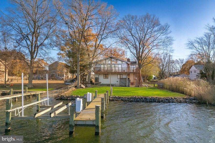 Nestled in the charming Deale Beach community, this beautifully renovated traditional home offers a perfect blend of comfort and waterfront living. The heart of the home features real wood floors, vaulted ceilings, a spacious updated kitchen with large island, and a cozy gas brick fireplace, creating a warm ambiance for any occasion.  This residence includes three bedrooms, including entry-level bedrooms for convenience, and two and a half bathrooms, ensuring ample space for relaxation. The master suite features a generous walk-in closet, providing both style and functionality. Step outside to discover your own slice of paradise with 60 feet of waterfront along Carrs Creek with private pier and 8000lb boat lift. Enjoy private access to the water. The rip-rap shoreline enhances the natural beauty while providing stability and protection. The lot itself is a serene retreat, offering picturesque views of the creek and a tranquil atmosphere. With off-street parking for up to four vehicles, convenience is at your fingertips. Located just moments from local amenities, including shops, restaurants, and recreational activities, this home is a true gem in a charming community. Experience the best of waterfront living in Deale Beach, where every day feels like a vacation. Don't miss your chance to make this enchanting property your own!