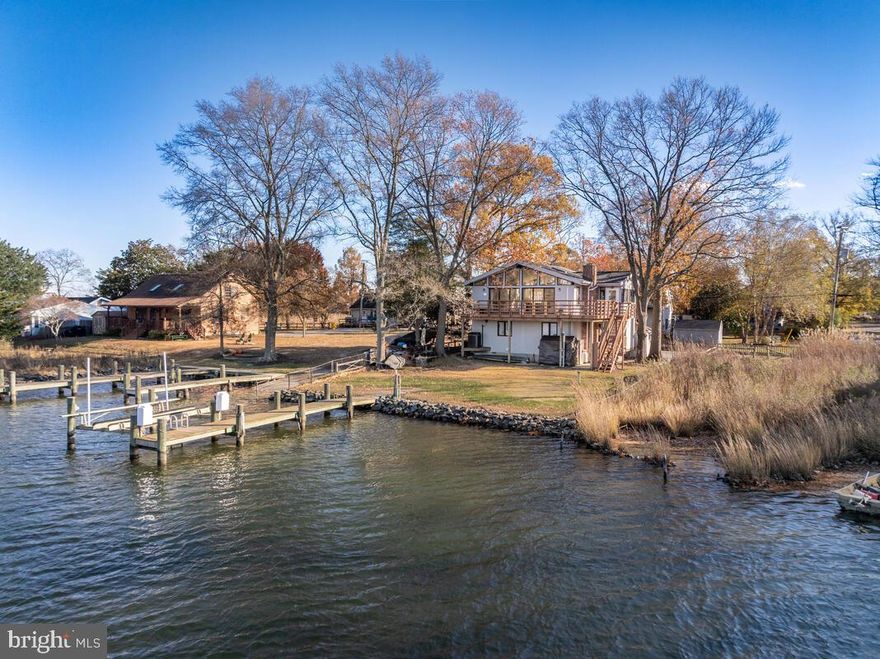 Nestled in the charming Deale Beach community, this beautifully renovated traditional home offers a perfect blend of comfort and waterfront living. The heart of the home features real wood floors, vaulted ceilings, a spacious updated kitchen with large island, and a cozy gas brick fireplace, creating a warm ambiance for any occasion.  This residence includes three bedrooms, including entry-level bedrooms for convenience, and two and a half bathrooms, ensuring ample space for relaxation. The master suite features a generous walk-in closet, providing both style and functionality. Step outside to discover your own slice of paradise with 60 feet of waterfront along Carrs Creek with private pier and 8000lb boat lift. Enjoy private access to the water. The rip-rap shoreline enhances the natural beauty while providing stability and protection. The lot itself is a serene retreat, offering picturesque views of the creek and a tranquil atmosphere. With off-street parking for up to four vehicles, convenience is at your fingertips. Located just moments from local amenities, including shops, restaurants, and recreational activities, this home is a true gem in a charming community. Experience the best of waterfront living in Deale Beach, where every day feels like a vacation. Don't miss your chance to make this enchanting property your own!