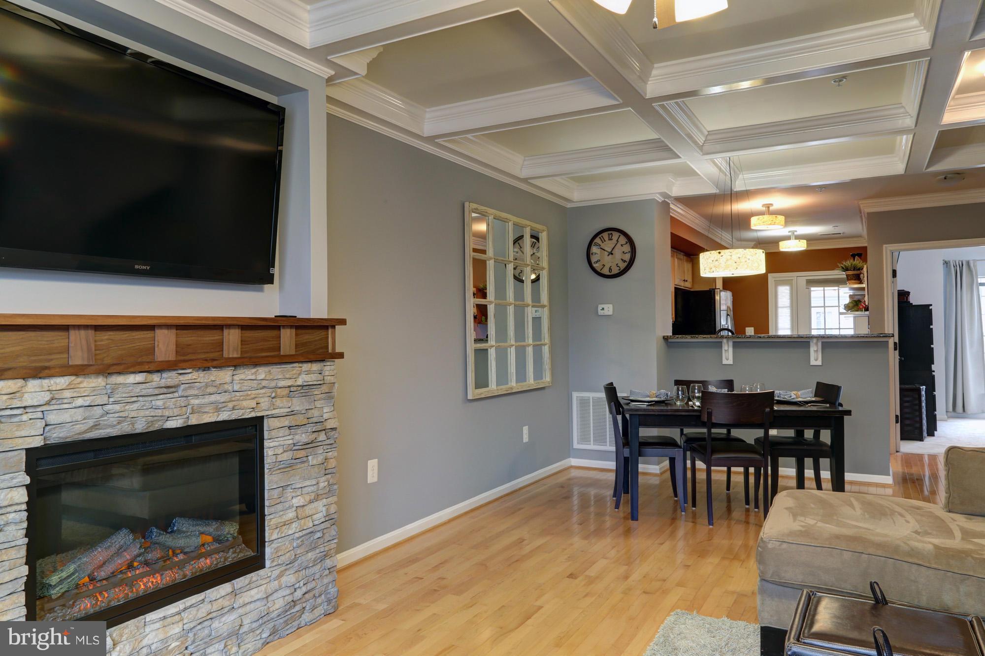 Restoration Hardware meets cozy townhouse! This home is stunning! Custom built stack stone gas fireplace and gorgeous custom coffered ceilings. Hardwood floors throughout. Gourmet kitchen with stainless, granite and office area. The second bedroom is exceptional with coffered ceilings, hardwood, and custom trim....if you have guests they won't want to leave!