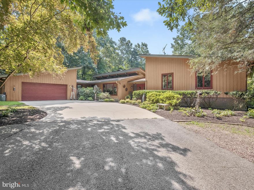 Welcome to an unparalleled oasis in prestigious Western Howard County complete with a second buildable lot, two story workshop, barn, tea house, tennis court, pool and spa and so much more. Nestled on over 6 acres, including a second buildable 2 acre lot with majestic landscaping and backing to state parkland. This stunning private property beckons with a serene heated in-ground pool and spa, perfect for relaxation and entertainment. Multiple picturesque ponds with goldfish and koi, expansive decks, a charming patio, a gazebo, a tennis court, and the gentle sounds of nature create a truly unmatched experience. As you approach, the circular driveway leads to double entry doors, unveiling an open floor plan highlighted by vaulted ceilings, gorgeous wood accents, and exposed beams. The living room exudes warmth with hardwood floors, a wood-burning fireplace adorned with a brick surround, and captivating views of a beautiful flower garden and koi pond. The formal dining room with a picture window seamlessly transitions to the kitchen, featuring a center island, ample storage, wine storage, and dentil-accented cabinetry. Conveniently, the kitchen provides access to a 2-car garage, laundry room, and powder room. The den offers a cozy atmosphere with a second wood-burning fireplace, perfect for unwinding. The primary bedroom suite is a sanctuary of tranquility, complete with a sitting room framed by glorious windows, a beadboard ceiling, and an en-suite boasting separate vanities and a luxurious glass door walk-in shower. Two additional bedrooms, one featuring dual lofts, and a hall bath complete the main level sleeping quarters. The fully finished lower level presents endless possibilities, including a recreation room, working studio with wet bar or potential bedroom suite with kitchenette, sunroom, ample storage, and a spacious office with plush carpeting. The exterior is a masterpiece with a tea house, sheds, barn and an impressive two story studio or workshop, rounding out this magnificent property. Conveniently located near major commuter routes, this property offers the perfect blend of luxury and accessibility. Discover the epitome of refined living in this remarkable Woodbine estate. This sale includes both lots 10 and 11, a buildable 2+ acre lot