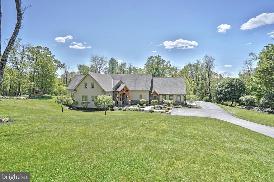 Looking for something special? You've found it here! No expense was spared on the construction of this exceptional, custom-built, post & beam home nestled on 4+ acres atop South Mountain. The expansive driveway welcomes you to this hidden retreat. This stunning red and white oak timber frame home offers over 4200sf of finished living space, 4 bedrooms, 4.5 baths, two 2-car garages, decks, patios, and an inground pool. Gleaming hardwood floors on the first floor.  In the center, a charming 2-story great room boasting a floor-to-ceiling stone fireplace is flanked by French doors leading to the composite deck with glass panel railing. Huge chef's kitchen features a massive center island, soft-close cabinetry, granite counters, upgraded appliances, and a walk-in pantry.  Walkout lower level to a covered patio with built-in gas grill and fire pit and just a few steps more to the pool deck. Room for everyone, rain or shine you will find places to enjoy. You have just found your happy place!