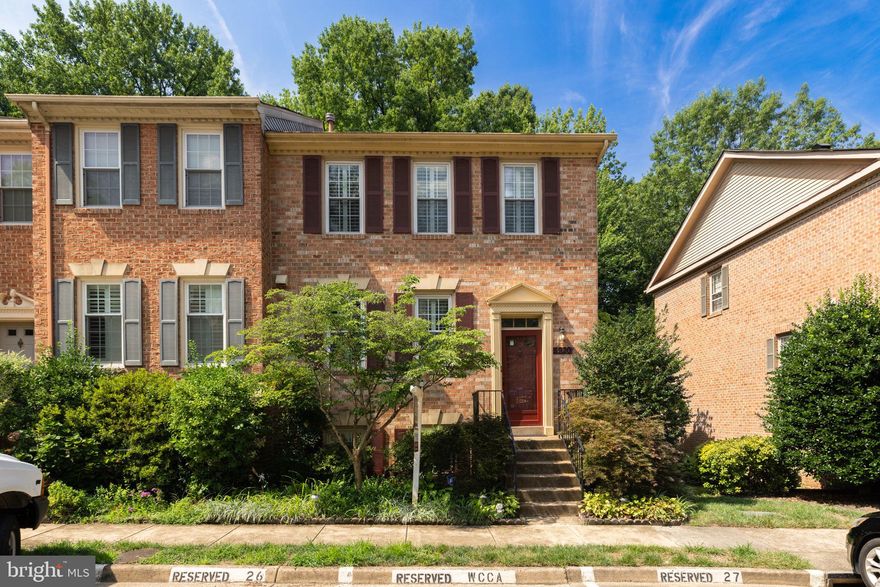 Welcome to 5920 Woodfield Estates Drive, an outstanding brick-front end-unit townhome backing to nothing but trees in Alexandria’s desirable Willow Creek! This 3-bedroom 3 and a half bath model has over 2500 square feet of living space and 2 assigned parking spaces. Gleaming hardwood floors grace the main and upper levels with plantation shutters and modern light fixtures throughout. The eat-in kitchen has recessed lighting, newer cabinetry, wide-plank tile flooring, stainless appliances, sleek granite counters, and a useful island with an overhang for barstool seating. The separate dining room showcases elegant box molding & chair rail, while both the living and dining rooms are enhanced by classic crown molding. The sizable living room also has recessed lighting and a large window that fills the space with natural light. From there, step out onto the oversized deck that spans the width of the home — an ideal spot for relaxing or entertaining with friends. Upstairs, two generously sized bedrooms each feature vaulted ceilings and ceiling fans. The tastefully renovated hall bath includes a chic vanity, tiled floor and floor-to-ceiling shower tile, complete with a luxurious rainforest showerhead. The owner’s suite offers a roomy walk-in closet with built-in shelving, an additional closet for extra storage, and a separate vanity with a sink located just outside the beautifully updated en-suite bath. The walk-out lower level features brand-new carpeting, a spacious third bedroom, laundry room and another nice full bath. The versatile rec room is centered by a cozy fireplace with a brick surround and detailed wood mantel. From here, step out through the sliding glass door to the private lower deck with built-in seating surrounded by mature trees, offering the perfect place to unwind. This fine home is super-close to Metro, all commuter routes, two Town Centers, and a quick hop to Old Town Alexandria!