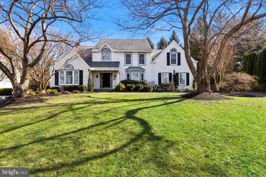 Nestled on a serene cul-de-sac, 721 Outpost Circle welcomes you with its beautiful façade, picturesque setting, featuring a lush lawn and perennial landscaping. As you step into the sunlit front hallway, you'll be greeted by a two-story entrance foyer, timeless molding, wide doors/openings and elegant hardwood floors. To the left, a cozy den with a charming peaked ceiling and an arched top window offers a tranquil retreat. On the right, a spacious formal dining room with bay windows provides an ideal space for hosting memorable gatherings. The open concept area boasts a spacious great room with neutral palette walls, complemented by a tiled gas fireplace and a wood mantel, creating a warm and inviting ambiance. The adjacent kitchen and breakfast area showcase modern elegance, featuring wood cabinets, granite countertops, stainless steel appliances, and a convenient island with stools and a built-in desk. The breakfast nook offers a custom-built banquette, perfect for enjoying morning coffee or casual meals. As you move through the home, a large mudroom and laundry area provide easy access to the back garden and two-car garage. Step outside through the back door to discover an enchanting back deck and patio, complete with two sets of awnings for shade and a tranquil herbal garden area within the fenced backyard. Upstairs, the remarkable primary bedroom offers a spacious retreat, featuring a cozy reading/tv nook, a built-in vanity station, and an outfitted walk-in closet. The modern adjoining primary bathroom exudes sophistication with neutral-toned tiles, grey double vanity cabinet with quartz counter, a freestanding tub, and a roomy walk-in shower. Three additional well-proportioned light-filled, carpeted bedrooms and an updated hall bath complete this floor.  The fully finished portion of the basement boasts luxury vinyl plank floors and high ceilings, offering versatile space for a den, office, and/or gym. The back unfinished area provides ample room for storage, ensuring that every need is met. This home has been updated, improved and meticulously maintained including newer systems and a whole house generator. Conveniently located near King of Prussia, Gateway Shopping Center, and downtown Wayne, this home offers easy access to major highways, parks, and nature trails, providing a perfect blend of convenience and leisure. In summary, 721 Outpost Circle presents a harmonious blend of comfort, style, and functionality, making it an enticing opportunity for discerning buyers seeking a welcoming and well-appointed residence.