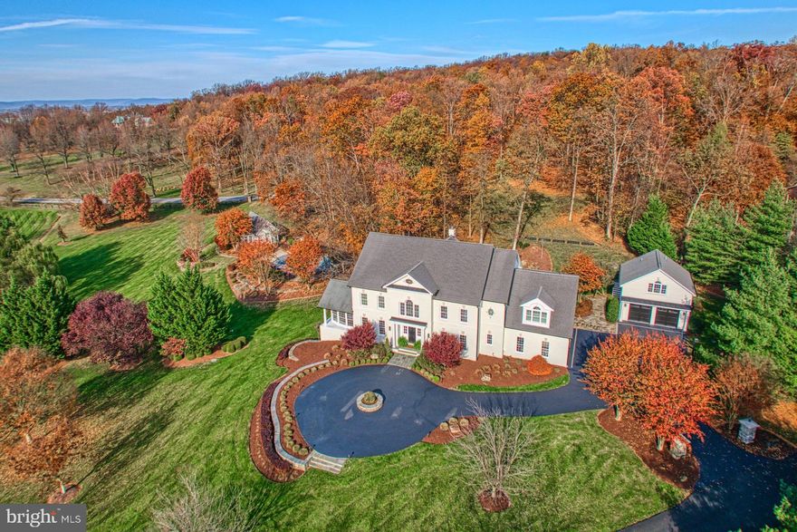 Hidden beyond a cul-de-sac entry within exclusive Beacon Hill, this estate enchants as traditional design blends effortlessly with chic sophistication. The home’s 8,189 square feet are dapper with a crisp modern palette, sweeping lines, refinished hardwoods, immaculate millwork, built-ins, and housewarming fireplaces. Outside, nearly four acres fill windows with scene-softening landscaping as woodlands add seasonal beauty to enclaves for yard games, summer barbecues, and your lightscaped pool. Here, the pool house, with bath and kitchenette, allows lazy afternoons with friends, while the sprawling clear pane-wrapped deck allows for unobstructed al fresco dining views. In your luxe kitchen, pack weekday lunches or pour glasses of cheer from under high-style pendants, while guests, at the stone-topped island, admire endless cotton-colored cabinets, high-end hardware, professional-grade, and a gorgeous barn-door-enclosed walk-in pantry. Work within a handsome inky-hued office with coffered ceiling, host holidays within living spaces of soaring ceilings and delicate fixtures and play within the lower level where you’ll recover within the in-home spa, view a rainy-day film, or add local favorites to the wine cellar. Start the day within five oversized bedrooms, two with en-suite baths. While your primary escape boasts dual custom closets, private laundry capabilities, and a refreshed spa-like bath, loved ones will wake within sunny bedrooms, utilize modern baths and, in the finished attic, enjoy the privacy of a tucked-away suite including full bath and place to unwind. While on tour, visit your home’s attached three car garage perfect for adventure equipment, weekend projects, and favorite classic cars, and tour the detached carriage house with an additional two car garage and efficiency suite apartment. From home, catch glimpses of wildlife along neighborhood trails, and enjoy travel routes to historic Leesburg, wineries, golf, OneLoudoun, IAD, and more.