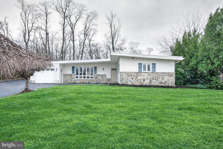 Tucked away in a quiet residential pocket of West Chester, 904 S Chester Road is an exciting opportunity to own a truly special home that perfectly blends style, comfort, and location! This gorgeous, completely renovated 4 bedroom, 2 full bathroom  ranch-style mid-century home with attached garage is filled with eye-catching design! A striking exterior features updated siding, classic stone accents, and an iconic sloped midcentury roofline. Set on a nice, usable lot, the home also boasts a rebuilt deck that invites you to relax, entertain, and enjoy the outdoors. In addition, the oversized attached garage can fit two cars back to back, allowing for plenty of hobby or storage space. Inside, you’ll love the bright and airy open-concept living, dining, and kitchen space, where large windows flood the home with natural light and a beautifully restored double-sided stone fireplace creates a stunning focal point. The brand-new kitchen is truly the heart of the home, showcasing attractive wood-toned cabinetry, stainless steel appliances, and quartz countertops. A center island offers generous workspace and flexible dining options. An additional separate room off the main living areas provides the perfect spot for a playroom, home office, or versatile flex space. The bedroom wing features four comfortable bedrooms, including a beautiful primary suite with a private bathroom and walk-in shower. A second full bathroom serves the remaining bedrooms with a tiled tub/shower combination. Convenient main-floor laundry adds everyday ease, and the thoughtful renovation throughout makes this home completely move-in ready. A brand new rubber roof and new, efficient electric heat pump will keep you warm and dry this winter. With its standout midcentury style, functional layout, and desirable West Chester setting, this home is an absolute must-see!