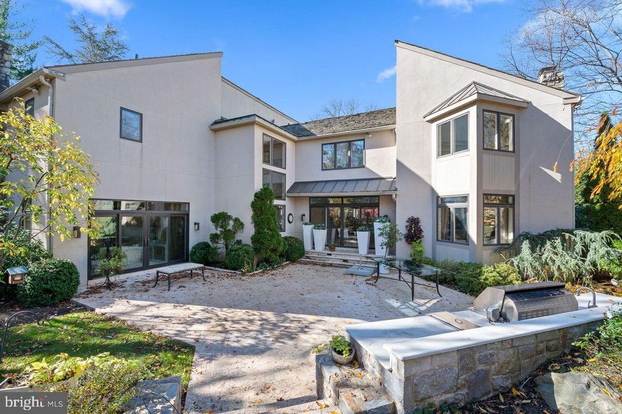 This stunning contemporary home features a grand two-story foyer that sets the tone for the luxurious living space within. As you enter, to your right is a step-down living room complete with a fireplace, a wet bar and sliding doors that open to a lovely back patio. To the left of the foyer, you'll find a powder room and a spacious home office with built-ins and gleaming hardwood floors.
The dining room is perfect for hosting elegant dinner parties. The large eat-in kitchen is a chef's dream, with pristine white counters, stainless steel appliances including a Subzero fridge and a Wolf oven, and a built-in desk. The kitchen also has sliding glass doors that lead out to another patio, making it ideal for indoor-outdoor entertaining. Adjacent to the kitchen is a family room with a second fireplace, perfect for relaxing and unwinding. Upstairs, the primary bedroom suite comprises a full bath with a dressing area and leads to an enormous walk-in closet complete with yet another full bathroom. A loft area - also accessible from the rear staircase - that can double as a bedroom and bonus room, is complete with a cedar closet. Down the hall, there is another bedroom with its own full bath. The exercise room also leads to another bedroom with a full bathroom. The lower level includes a finished area with a dry bar, a second kitchen, a game room, full bath and ample storage. The home also has a three-car garage. Outdoors, you'll find a pool and an outdoor kitchen, perfect for summertime gatherings.