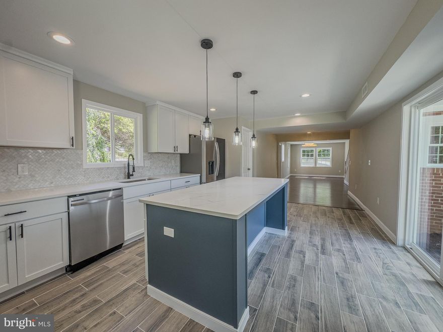 100% Financing Available with FNB Home Ownership Program for Primary Residence purchases up to $766,550. Get up to $5000 Closing Assistance with Credit scores as low as 620. Call for Details. You don't want to miss this move-in-ready gem in Reisterstown, MD! This beautifully rebuilt brick home features 5 bedrooms, 3 bathrooms, and a finished basement on a spacious 0.57-acre lot in a serene neighborhood. Every inch of this home has been meticulously updated with modern features to meet all your needs. Step inside to discover a wealth of space designed for entertaining and comfortable family living. The gourmet kitchen is a chef's delight, showcasing a large center breakfast island, stainless steel appliances, stunning pendant lighting, and a sophisticated white braided stone backsplash with granite countertops. The open-concept design seamlessly connects the kitchen to the dining room and family room, making it perfect for gatherings. The inviting living room boasts a cozy wood-burning fireplace, ideal for those chilly evenings. The main level also includes a versatile fifth bedroom that can easily serve as a home office, providing the perfect workspace for those who work from home. Upstairs, the primary bedroom and bathroom suite offer a luxurious retreat, complete with ample closet space and a beautifully appointed bathroom. Three additional bedrooms and a full bathroom ensure plenty of room for family and guests. The home is filled with natural light, thanks to numerous large windows, and features hardwood floors throughout the main level and plush carpeting upstairs. Convenience is key to a well-placed mudroom and laundry room off the side entrance. The lower level is a bonus, featuring a spacious recreation room, an additional bonus room, and a large utility room with a bathroom rough-in for future expansion. Outside, the large patio and generous yard provide an ideal setting for outdoor activities and relaxation. Ample parking ensures convenience for residents and guests alike. Located close to Wegmans, movie theaters, restaurants, fitness clubs, and parks, this home offers the perfect blend of tranquility and accessibility. Don’t miss the chance to make this exquisite property your forever home!