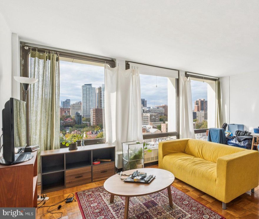 Sun-soaked studio with sweeping Center City views at Society Hill Towers! Enter through a foyer with large coat closet into the open great room boasting ample space for everyday living and entertaining and a wall of floor-to-ceiling windows showcasing spectacular Center City views. Adjacent is the galley-style kitchen with ample cabinetry. There is a dressing area with excellent closet space that leads to the upgraded bathroom with modern white vanity and tub shower with white tilework. There are parquet wood floors throughout. Residents of Society Hill Towers enjoy a 24-hour doorman and all utilities plus basic cable. Access to the building's outdoor seasonal pool, fitness room, storage lockers, and parking in the building's underground garage are available for an additional fee. Also, there is an on-site Philly Car Share, a coin operated laundry room in the basement, and a shopping plaza on site with a market, dry cleaner, beauty salon, and one of Philly's most acclaimed restaurants, Zahav.