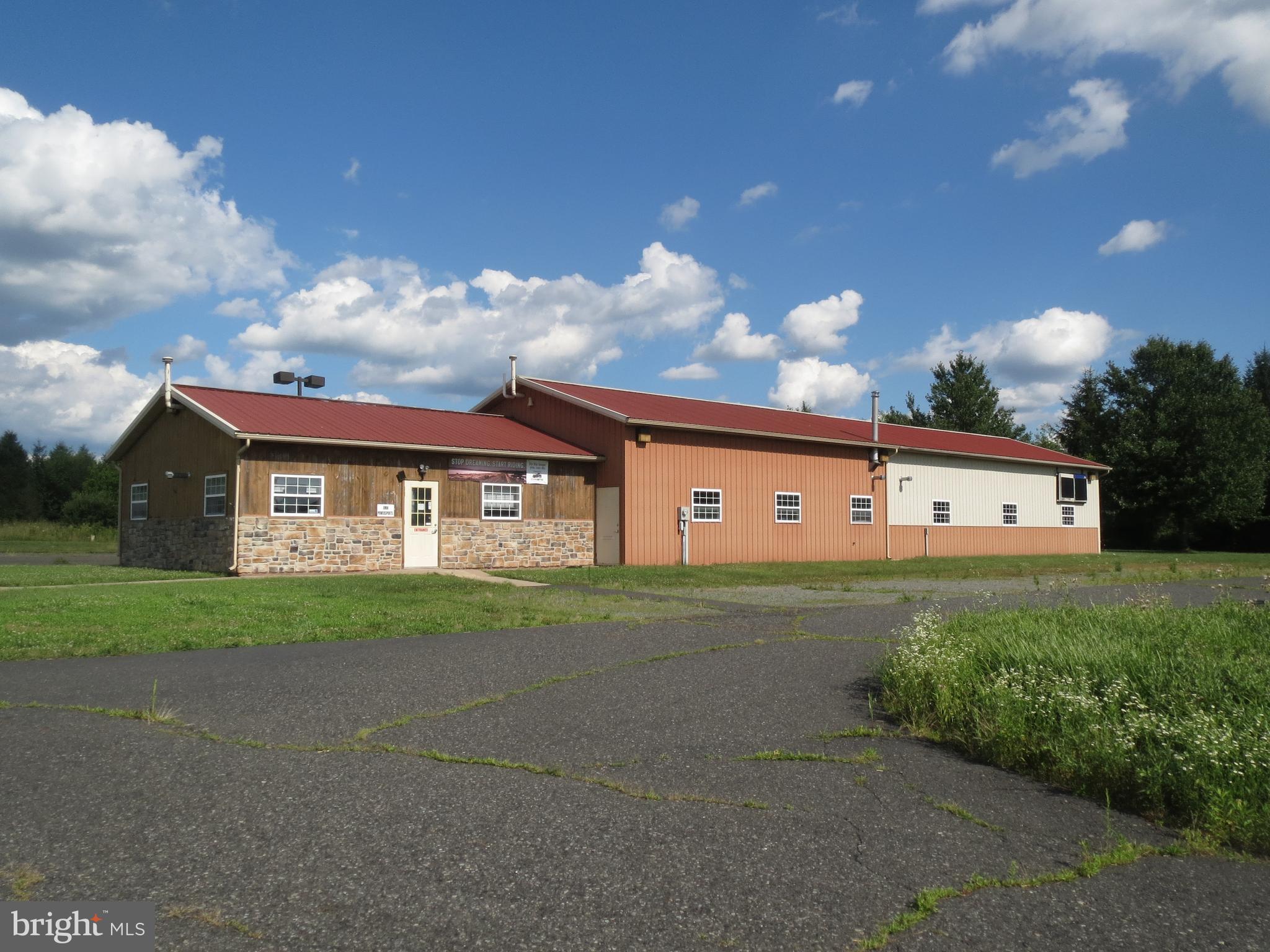 Current tenant pays $2900/month The doors are 10' X 10' and the ceilings graduate from 11' to 13' 6" at the peak.