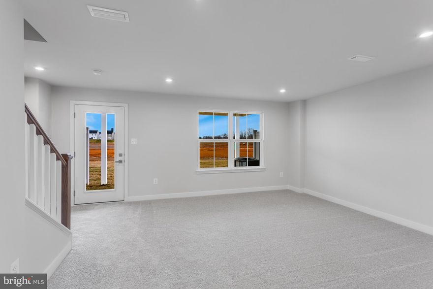 Why pay Maryland or Northern Virginia prices when you can get more space and more upgrades just minutes away? This quick move in Ballad townhome offers nearly 2,000 square feet across three finished levels, designed with MD/VA commuters in mind. The flexible entry level recreation room is ideal for a home office, guest space, or second living area, while the open main level features luxury vinyl plank flooring, quartz kitchen countertops, soft close linen cabinets, stainless steel appliances, and a large center island. Step outside to your spacious 10’ x 18’ deck, perfect for relaxing or entertaining. Upstairs, the owner’s suite offers a private retreat with a well appointed bath with Roman Shower and ceramic tile surround showers, plus convenient bedroom level laundry. Located near Route 9 for easy access to Maryland and Northern Virginia, this home delivers new construction peace of mind, immediate availability, and long term cost savings without sacrificing lifestyle or convenience. Come visit our model home at: 1741 Destrier St, Ranson, WV, 25438