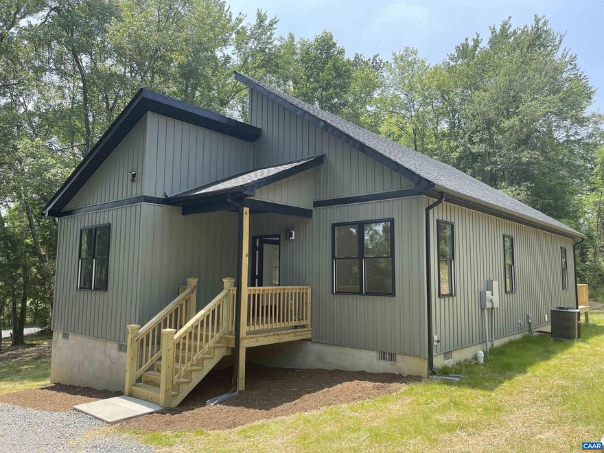 Just 20 mins to Charlottesville &Less than 5 mins to Shopping and Scottsville! Premium QUALITY new custom stick built construction. Stylish contemporary one level with a open front to back floor plan that features: full length 18 ft vaulted ceiling with windows; Great room, dining area, kitchen with large island with seating, granite countertops, premium stainless steel appliances, pantry; FIRST FLOOR OWNERS SUITE with 2 closets, access to the rear deck, master bathroom with his/her vanity, walk in tiled shower; hall bath with tile floors and tub/shower surround; black windows and board and batten vinyl siding; front porch and rear deck. Nice level private corner lot.; 5min from historic downtown Scottsville, grocery store, hardware store etc. Internet is with Brightspeed, formerly CenturyLink. The attic is floored front to back for storage. Owner/agent,White Cabinets