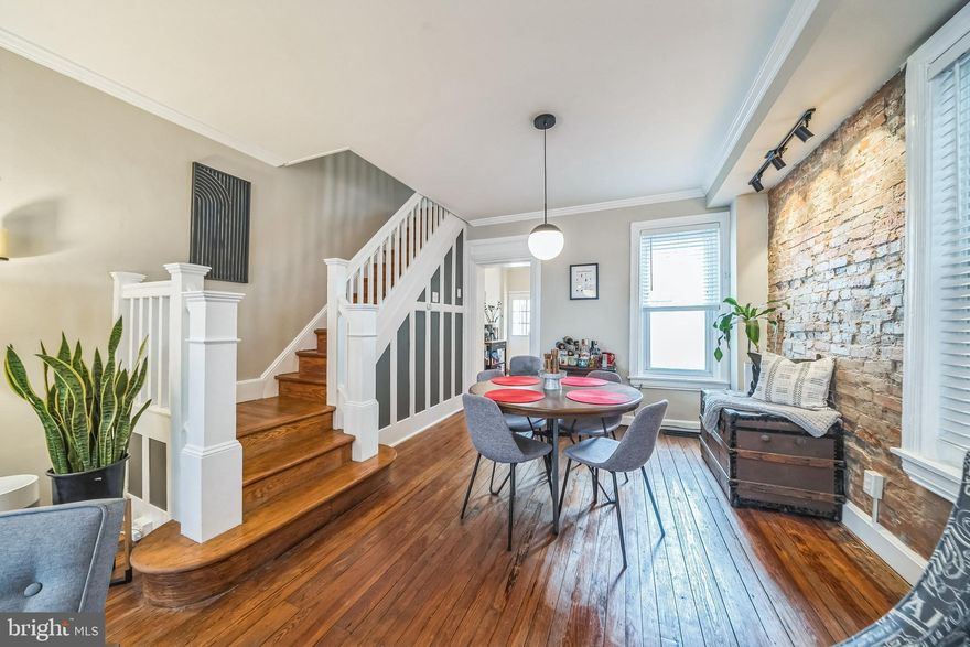 Welcome to 3877 Manor Street—an incredibly well-maintained two-bedroom mid-block end of row home on a quiet block in the heart of Manayunk. This one has the space, updates, and location that make it an easy yes.
The first floor features 9-foot ceilings, original hardwood floors, and a full-length exposed brick wall that adds charm and warmth to the open living and dining areas. The staircase showcases original woodwork and ornamental detailing, maintaining the home's historic character. Throughout, you'll find matte black hardware that provides a sleek, contemporary touch while echoing the character of the home.
The kitchen has great light and provides plenty of counter and cabinet space. Beyond the kitchen is a private deck—ideal for entertaining or relaxing outdoors. Never worry about lugging around propane tanks again with a dedicated natural gas line for your grill. An additional benefit is that the lot faces the stone retaining wall that runs along Hermit Street, providing a serene and peaceful environment with no rear neighbors.
Upstairs are two generously sized bedrooms with 8'6" ceilings and an oversized full bath that was once a third bedroom, so you’ve got the extra room where it counts. Original hardwood floors and the same attention to detail continue up to the second level. 
The basement has 7' ceilings, built-in storage, laundry, and plenty of space for whatever you need. The central heating and air system and the sewer line connection at the street was replaced in 2020, so the mechanicals and systems are solid and ready to go.
Located less than a block from SEPTA bus service, a 10-minute walk to the train station, and close to the shops, restaurants, and trails that make Manayunk so desirable. There’s also a playground and community green space just down the block.
This home offers the kind of quality and care that’s increasingly hard to find—thoughtfully updated while retaining its soul. Showings begin after the first open house Friday April 11th 5-7pm, don’t miss out on an incredible opportunity in one of Philadelphia’s most coveted neighborhoods!