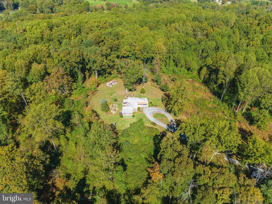 OFFERS DUE BY 3PM SUN OCT 22nd. Amazing Contemporary rancher home home nestled on 30 tranquil acres with  stream, trails & 2 additional building rights (build homes for family members, subdivide or use for your own "recreation or nature escape" ).  Light-filled home offering one level living featuring vaulted ceilings & open concept main living area &  updated flooring throughout . Newly updated Kitchen w/new SS appliances. quartz counters, cabinets w/soft close drawers  & built-in breakfast nook.  Primary bedroom suite addition w/vaulted ceilings, transom windows. French doors to relax on your private deck. primary bath w/walk-in shower.  2-3 additional bedrooms (one is great office-craft room) with large hall bath with soaking tub & walk-in shower.  Spacious mudroom w/laundry & built-in cabinets &, counters with plenty of storage.  3 season screened porch, deck & PA Quarry slate patio to relax, grill and entertain . Carport and circular driveway (conveniently park multiple vehicles). 2 Zoned HVAC system . New well pressure tank (2020).  New roof (2014). Outbuildings for storage & workshop.  Nothing to do but pack your bags and move in !  Convenient access to I-95.