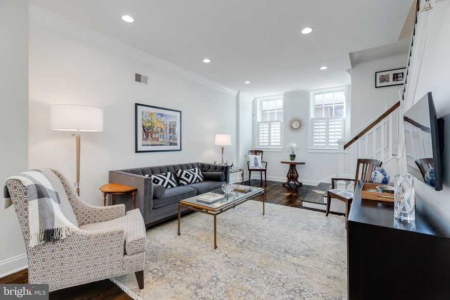 335 S 6th St is a thoughtfully renovated 2,502 sqft historic home teeming with original character, modern updates, and architectural details. Situated just across from the highly sought-after McCall School in picturesque Society Hill, this 4-story home offers 4 bedrooms, 2.5 bathrooms, a finished basement, and multiple outdoor spaces. Out front, you're greeted by a classic Philadelphia red brick facade, with shutters flanking the windows, lively planter boxes, and a vibrant red door. Inside, a tiled vestibule leads to an open, bright, and airy main level with gorgeous hardwood floors. Custom wood shutters allow natural light to stream into the living room through two towering windows. Intricate millwork is displayed in the crown molding that frames the 9ft ceilings and the wainscotting tracing the staircase. A fireplace mantle anchors the dining area. The home's sleek, designer kitchen is fit for a chef, with tall two-tone shaker cabinets, high-end Sub-Zero and Dacor stainless steel appliances, and quartz counters that extend up the backsplash. Thoughtful touches include a wine fridge, a peninsula with seating, pantry space, and an exposed brick wall. Off the kitchen, a large secluded patio acts as a quiet escape from the city's hustle, perfect for hosting family and friends. Completing the main level is a powder room, coat closet, and built-in shelving. On the lower level, there's a carpeted bonus space that could be used as a media room, playroom, or fitness room. There's also lots of storage space and a laundry area. The second level of the home is dedicated to the primary suite. There's a massive bedroom with hardwood floors, tall windows, and two walk-in closets. The luxurious bathroom is adorned with a double vanity, a soaking tub set against a tile wall, and a rainfall shower. The suite also has a peaceful balcony, ideal for enjoying a morning cup of coffee or evening glass of wine. The home's third level has large, bright bedrooms at each end and a modern full bathroom. Topping off the home is an expansive dormer bedroom perfect for guests or a rec room. In addition to everything inside 335 S 6th St, its fantastic Society Hill neighborhood can't be beaten! This central location earns a Walk Score of 99, with plenty of top-rated restaurants, friendly shops, and popular markets to explore nearby. It's also close to idyllic Washington Sq Park, Pennsylvania and Jefferson Hospitals, Center City, and Independence Mall. Plus, there's easy access to public transit, I-95, I-676, and South Jersey. Schedule your in-person or virtual showing today!