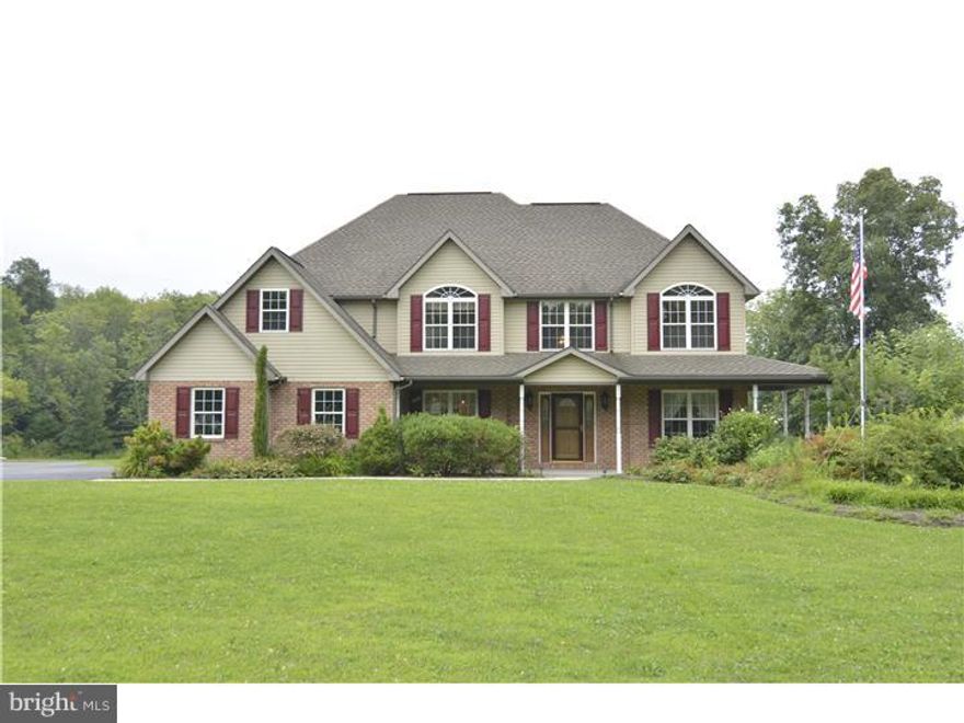 This gorgeous custom built 15 year young home offers over 4,500 sq./ft. of living space and is situated on a beautiful flat 4.5 acre lot located in the Hamburg School District. 4 possible 5 bedroom, 2.5 bath, just in the home itself. Covered porch enters into two story foyer with beautiful hardwood flooring and open switchback staircase. To the right you will find the formal living room or home office and to the left is the formal dining area. Ahead is the two story family room with beautiful gas burning brick and slate fireplace, surround sound and loads of natural sunlight from the many windows the home has to offer. The 46 handle oak kitchen is every cooks dream with double sink, tile back-splash, large island, Jen Air cook top and wall oven, overlook to family room, with tons of windows and beautiful wood trim there is even a desk area to organize all your recipes. Breakfast nook just off the kitchen has slider to large patio with trellis. Convenient first floor laundry,    bath and office/first floor bedroom complete this floor. Upstairs across the catwalk you will find the master suite of your dreams with slider to your second floor deck and huge master bath with 2 person jetted tub, and large walk in closet. Three more generous sized bedrooms and another full bath complete the second floor. The lower level is the complete man cave. Large built in bar with plenty of room for all your friends, gas fireplace, pool table in gaming area and a separate media area. The yard is large and flat with a stream at the very back of the property and offers endless possibilities. Heated detached 3 car garage is an absolute car enthusiasts dream, with one 10' high door, and generator ready. Above the garage there is an additional large living area offering 2 bedrooms, 1 bath, full kitchen, washer/dryer hook up and lots of natural light from the skylights. An extra full living quarters, great for that college student, possible in-law suite, extended family or even a temporary stay. Spiral stairs lead from the lower level of the garage to the upstairs or you can access from the private outside stair case. This home has so much to offer, just minutes from I-78, and is priced to sell quick! Call today to schedule your showing.