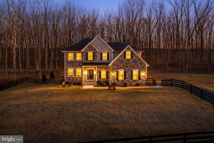 Welcome home to a perfect blend of space, serenity, and style. This exceptional property offers 5 private acres of rolling land, partially fenced and backing to mature woods, creating your own personal retreat just minutes from historic downtown Winchester, Valley Health Medical Center, local wineries, and commuter routes. Step inside to a bright and welcoming open floor plan, where gatherings come naturally. The heart of the home is a huge gourmet kitchen, featuring gleaming quartz countertops and seamless flow into a cheerful sunroom and a sprawling composite deck—ideal for everyday living and entertaining.
The main level is thoughtfully designed for comfort and convenience, featuring a cozy family room with a coffered ceiling and a striking stone fireplace, a private office/den, and a main-floor bedroom with its own ensuite bath—perfect for guests or multi-generational living. Upstairs, escape to your spacious primary suite, a true sanctuary featuring a spa-like bathroom with a freestanding tub, a separate shower, dual vanities, and an impressively massive walk-in closet. Two additional bedrooms enjoy the privacy of their own ensuites—one includes a flexible bonus space for an office, nursery, or sitting area. A fourth bedroom and a hall bath complete this level. The finished lower level is your entertainment haven, complete with a large, versatile room ready to become your home gym, rec room, theater, or more—the possibilities are endless. A full bath and ample storage complete this flexible space. Don’t miss your opportunity to make this peaceful, well-appointed property your new home. Schedule your private Tour today!