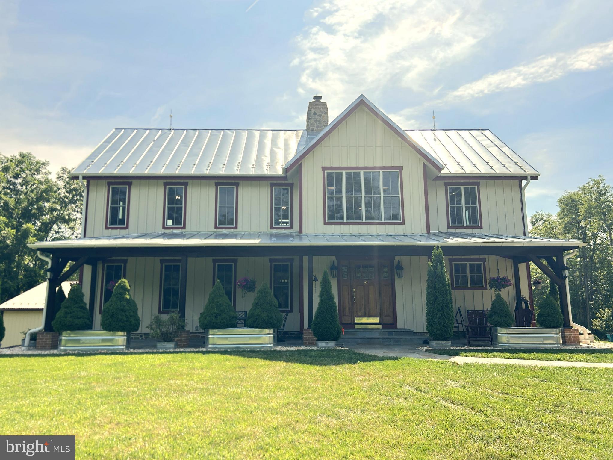 Upcoming auction on Saturday, September 27th at 12 noon. Let this paved scenic driveway lead the way to the house of your dreams. Built in 2017, this 2712 Square foot, three bedrooms, 2 1/2 baths, custom built home, sitting on 64 acres, is truly one of a kind. The main level of this home encompasses an open floor plan consisting of a large kitchen, dining room, and family room. The main floor also includes a primary bedroom and its own private bathroom, a laundry room, and a half bath. The main level of the home has access to a large raised deck with a hot tub and views that will take your breath away. The second floor of this home encompasses a wrap around balcony, 2 bedrooms, a full bath, and an office area. This home features 26 foot tall with 360 degree stone fireplace that can be viewed from both the main level and the second floor of the home, and a barn / log wood beam interior. The unfinished basement boasts access to the rear patio area, two garage bays, a multipurpose room, and a utility room. In addition, the house has a generac guardian whole house generator. On top of the home's amenities, the property along with a detached three car garage, a detached machine shed, a three sided shed, a pavilion with a brick fireplace, and a fire pit area. If you're looking for a secluded property, ordering Cunningham Falls State Park, with lots of opportunities for entertainment and recreation, endless Wildlife and peacefulness, you do not want to miss out on the chance to make this property yours. List price in no way represents the minimum, starting, or acceptable bid. It is used as a guide to find the home.