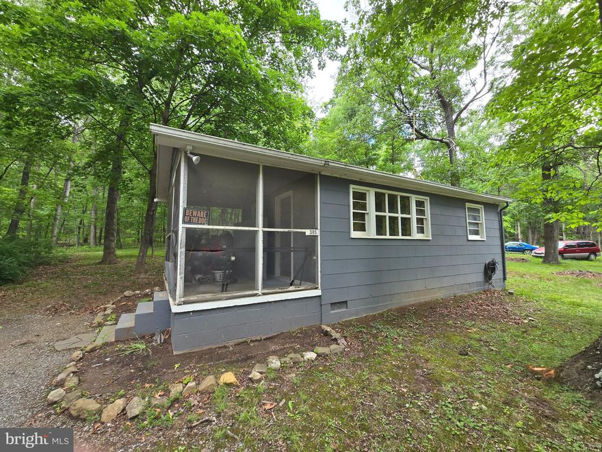 Escape to this cozy 1-bedroom cottage, nestled on a level wooded lot—a perfect blend of comfort and rustic charm. Inside, you'll find knotty pine walls and hardwood floors that create a warm and welcoming atmosphere.

Unwind on the screened-in porch, ideal for sipping your morning coffee or watching wildlife in the peaceful, natural surroundings. Whether you're looking for a weekend retreat, a full-time residence, or a rental investment, this charming cottage offers endless possibilities.

Don’t miss this rare opportunity to own a tranquil slice of nature—complete with all the comforts of home.
Sold AS IS, any inspections are for buyer's informational purposes only.