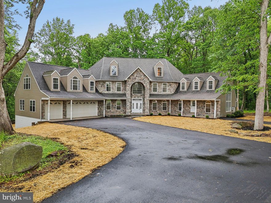 Discover the perfect blend of luxury, space, and privacy at this one-of-a-kind estate in the heart of Woodstock. Nestled on more than 8 wooded acres, this fully renovated home offers six spacious bedrooms, six beautifully updated bathrooms, and more than 11,000 square feet of elegant living space. Step into a grand two-story foyer with a soaring cathedral ceiling and gleaming hardwood floors, setting the stage for an extraordinary living experience. The gourmet country kitchen is a chef's dream, featuring new white cabinetry, quartz countertops, a center island, top-of-the-line stainless-steel appliances and a charming breakfast nook with a bow window. Entertain with ease in the expansive family room, boasting a cathedral ceiling, a wall of windows and a stone fireplace. Enjoy the outdoors from your new deck, surrounded by mature trees offering total seclusion and peaceful views. The luxurious primary suite offers a serene retreat with a gas fireplace and en-suite bath featuring a soaking tub and a custom walk-in shower. A unique highlight is the attached in-law suite with a separate entrance, offering a living area, full kitchen, office/den and laundry, perfect for guests or multi-generational living. Additional features include bonus rooms ideal for a theater or game room, a three-car garage and a second garage with ample storage and workspace. Located just minutes from major routes, shopping, and dining—but feeling worlds away— this home is a rare opportunity for refined, private estate living.