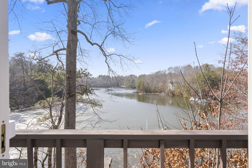 Welcome to this 4-bedroom, 3-bath waterfront home in Drum Point, offering an impressive 300 feet of waterfrontage and easy access to a private beach club. Enjoy expansive, undisturbed panoramic views of Mill Creek from nearly every angle. The main level features three bedrooms, new flooring, recessed lighting, and a bonus Florida room that fills the home with natural light and opens to a rear deck overlooking the water. The fully finished lower level offers exceptional flexibility with a private 1-bedroom suite, full bath, kitchenette, new carpet, and a wood-burning stove. Ideal for guests or extended living. Step outside to swim, relax by the water, or boat from your own private dock with an 8,000 lb boat lift. This home has been thoughtfully updated, including vinyl windows, roof, seamless gutters and downspouts (2015). Additional improvements include the water heater, washer, and dryer (2017), HVAC system (2022), upgraded attic insulation (2022). This is a rare waterfront opportunity offering space, comfort, and an exceptional setting. Mortgage savings may be available for buyers of this listing.