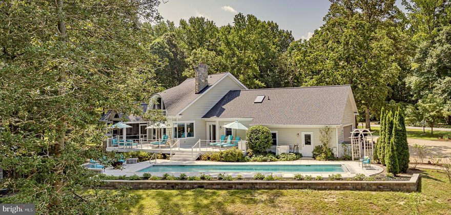 This premier single family or multi-family compound boasts the quintessential river feel with a modern updated design. With a 3800 sq ft main home and a 1770 sq ft guest house (each with its own utilities/systems), this is an ideal property for several generations or multiple owners. The 2+ acre property with 231 feet of Carter’s Creek waterfrontage and a gently sloping shoreline out of the flood zone boasts an architecturally stunning main home with breathtaking water views and a custom guest house perched on a landscaped knoll overlooking the creek. This property features exceptional outdoor living space to include a waterside, heated 48’ lap pool, screened porches and decks off both the main home and guest house and dock to 5’ MLW with 3 slips, 2 lifts and a kayak launch.  The main home offers open living space with vaulted ceiling, designer fixtures, a floor to ceiling stone fireplace and a kitchen with premium appliances and fully equipped butler’s pantry.  The primary suite includes a waterside bedroom, his/hers full baths and dual closets, a sunny office with space for an art studio or reading chair and a separate dressing area. The main level also includes a bedroom with huge views and an ensuite bath with zero-entry tile shower, a powder room and a 2 car attached garage. The walk out lower level features a family room with wet bar, bedroom, full bath, sauna, wine closet and covered waterside patio.  The custom modern guest house features a 2nd floor open-plan living space with oversized kitchen island, bar counter with wine fridge, ensuite bedroom and half bath with laundry. Two first floor bedrooms with hall bath, attached garage with electric charging station and both car and golf cart parking and the third floor office make this home perfectly sized for extra family and friends.   This property is everything a luxury river home can be, replacing the sites and sounds of city life with the sparkle of sunshine on water and the hum of a boat motor crossing the creek. Only 1 hour and 20 minutes from Richmond, this luxury family compound is filled with natural light and plenty of entertaining spaces. With restaurants and grocery store choices within minutes, this location has it all.