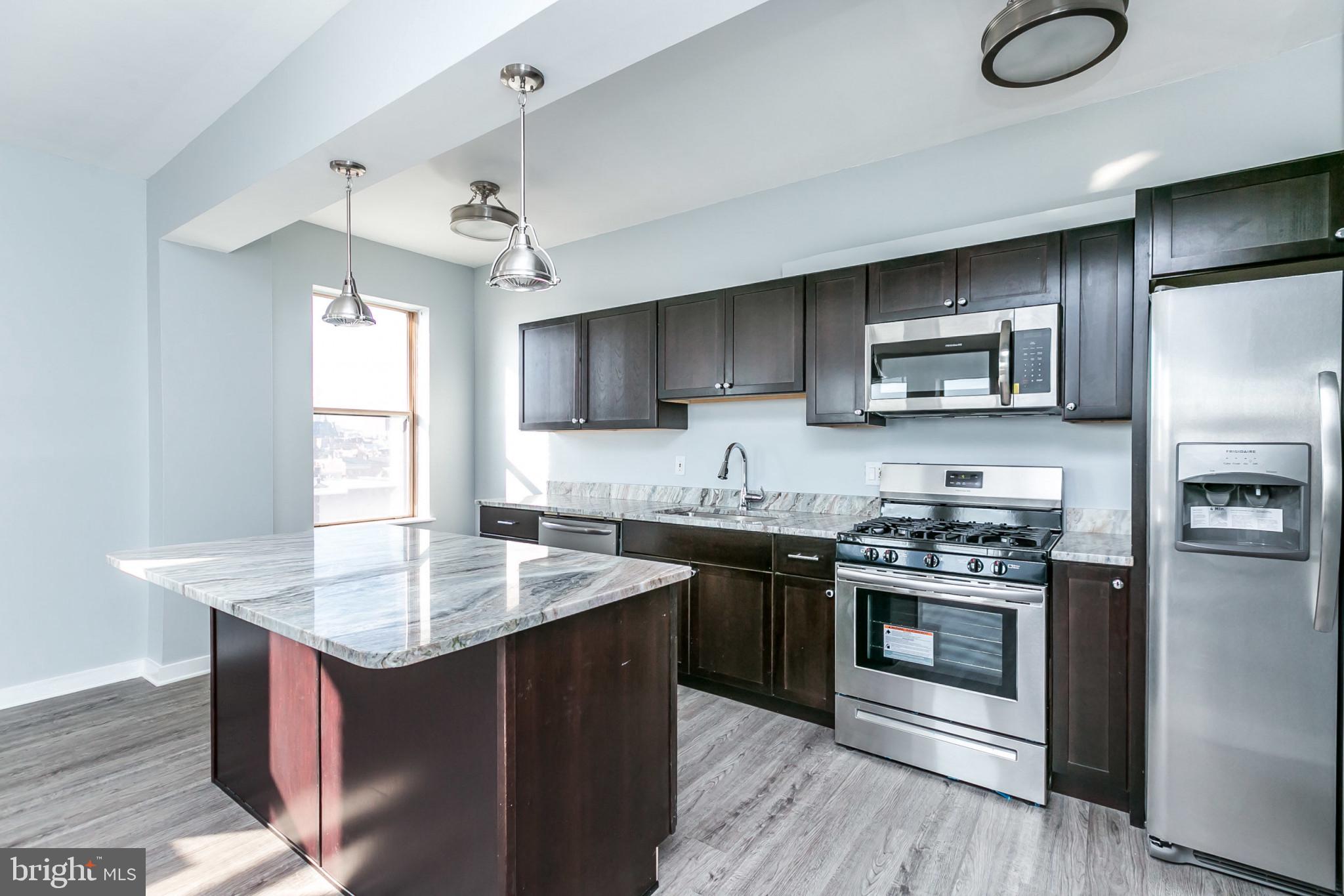Welcome to Unit 12H – a chic, high-floor one-bedroom home in the heart of Baltimore’s historic Mt. Vernon neighborhood.
Completely remodeled in 2021, this thoughtfully redesigned residence blends contemporary comfort with timeless charm. Traditional walls that once separated the kitchen and living room were removed to create a modern open-concept layout, offering seamless flow, elevated style, and easy communication throughout the space.
At the heart of the home is a chef-inspired kitchen featuring a large island that doubles as a dining area, abundant cabinetry, and sleek finishes – perfect for cooking, entertaining, or everyday living.
The corner unit offers sweeping city views. A brand-new HVAC system ensures quiet, efficient heating and cooling all year round.
The spacious bedroom is a true retreat, featuring a wall-to-wall walk-in-style closet that provides generous storage without sacrificing design. It’s both functional, perfect for organizing wardrobes and accessories with ease.
Residents enjoy a suite of amenities including 24/7 front desk security, secure package pickup/drop-off, laundry facilities in the basement, and a rooftop deck offering breathtaking panoramic views of the Baltimore skyline.
Garage parking is available for lease on a first-come, first-serve basis for $160/month (parking space does not convey with the unit).
Just a 10-minute walk to Penn Station and the Light Rail, this prime location offers unmatched convenience. Discover the vibrant culture of Mt. Vernon – from art galleries and theaters to the Baltimore Farmers Market and nearby Johns Hopkins and UMD shuttle stops.
Whether you're a first-time buyer, student, or investor, Unit 12H delivers style, space, and an unbeatable city lifestyle.