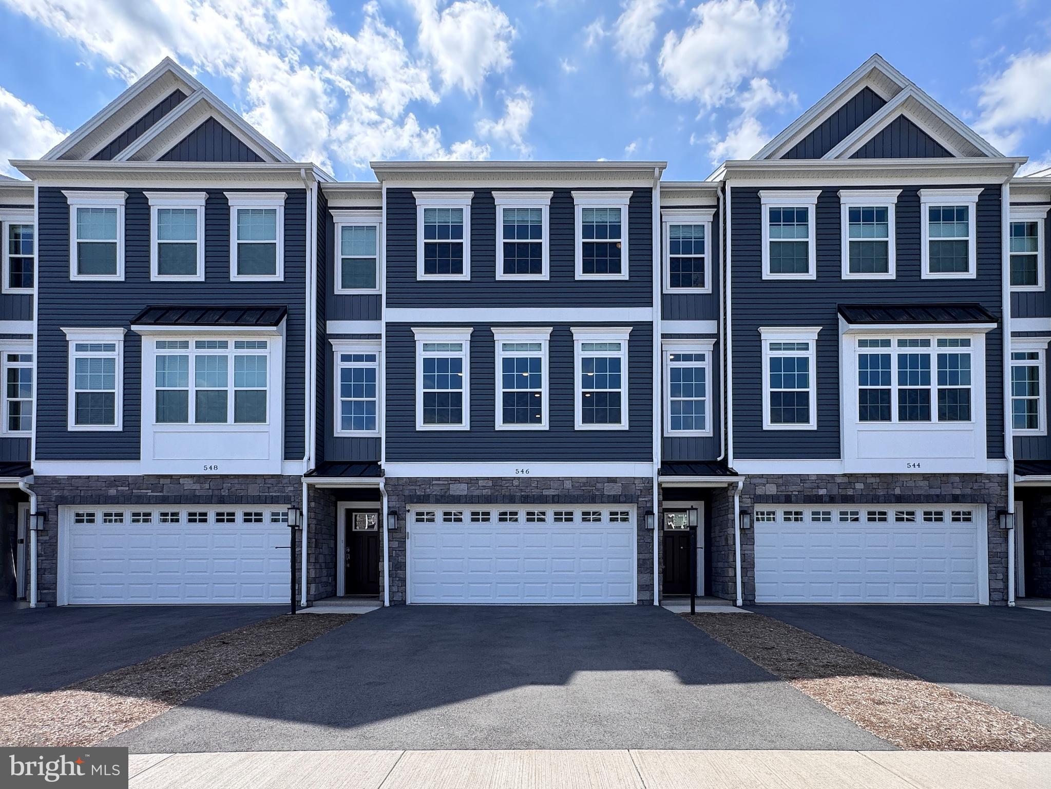 Whether you're looking for your home away from home or primary residence you'll love the fabulous upgrades and sweet sense of home at 546 Brandywine Drive in desirable Canterbury Ridge. This just two year old three story townhome features a STATE-ly vibe and is a great place for entertaining! You'll love the beautiful open floor plan with a fabulous gourmet kitchen featuring quartz countertops, a large island, upgraded white tall cabinets, SS appliances, gas range, pantry cupboard, and stylish backsplash. Host laughter filled dinner parties in the lovely dining room or share a cocktail at the end of a long day on the back deck. From Gameday to cozy nights in, you'll love the spacious light and bright living room with electric blinds. The entire home has been upgraded with LVP flooring throughout, custom blinds, and custom stair runners have been installed on the staircases. Working from home will be a breeze in the first floor office with glass French doors, built-in desk and shelves, and half bath. Upstairs you'll find a peaceful primary suite with large windows, big walk-in closet with closet system, and a private bath with tile floors, walk-in tiled shower with glass doors, and double vanity. Two additional nicely sized bedrooms, one with a walk-in closet, a lovely full bath with tub/shower, and laundry complete the 2nd level. Downstairs you'll love having the additional 4th bedroom, currently set up for guests with private bath ensuite and egress, also a wonderful optional space for an exercise room, study, or family room. The two car garage with storage systems & upgraded epoxy garage flooring provides parking and great additional space! A great neighborhood for walking, biking, and just enjoying the outdoors, you'll appreciate the close proximity to Mount Nittany Middle and Elementary Schools and the quick commute to campus and the stadium! The reasonable monthly condo fee includes trash, landscaping, snow removal, and exterior maintenance. Come and check out this special home today!
