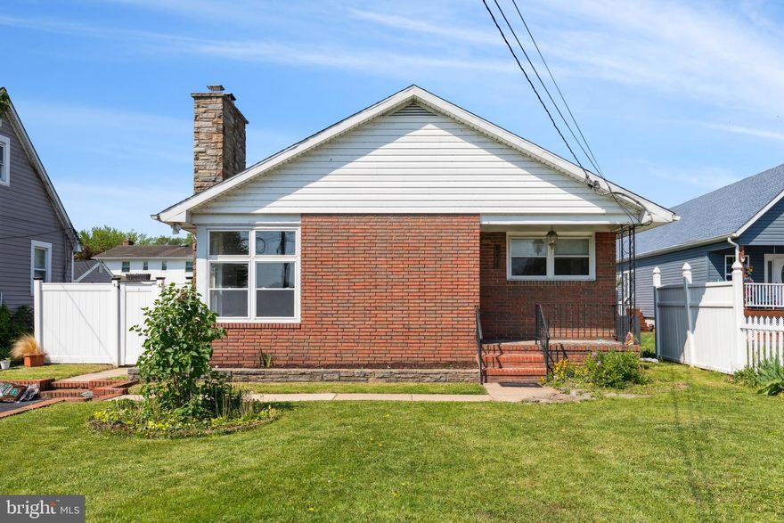 Beautiful, brick rancher nestled within Rosewald Beach.  Picturesque view of the water from the living room.   Open concept with plenty of natural light.  Brick fireplace in the living, one bathroom and 3 bedrooms on the first floor which opens to the dining room and plenty of room for a sit-down kitchen.  Additional room off the kitchen for entertaining or playroom.  Prior owners used to steam crabs and entertain in this room. Separate bathroom in storage area of first floor.  Hardwood floors throughout, some areas are covered by carpeting.  Large basement with pool table, large wet bar, another brick fireplace, full bathroom with shower and laundry room.  Great entertainment area! Newly installed French Drains are in the basement.  Just across the street within walking distance is the community pool.  Two car driveway with plenty of extra parking across from this home.
