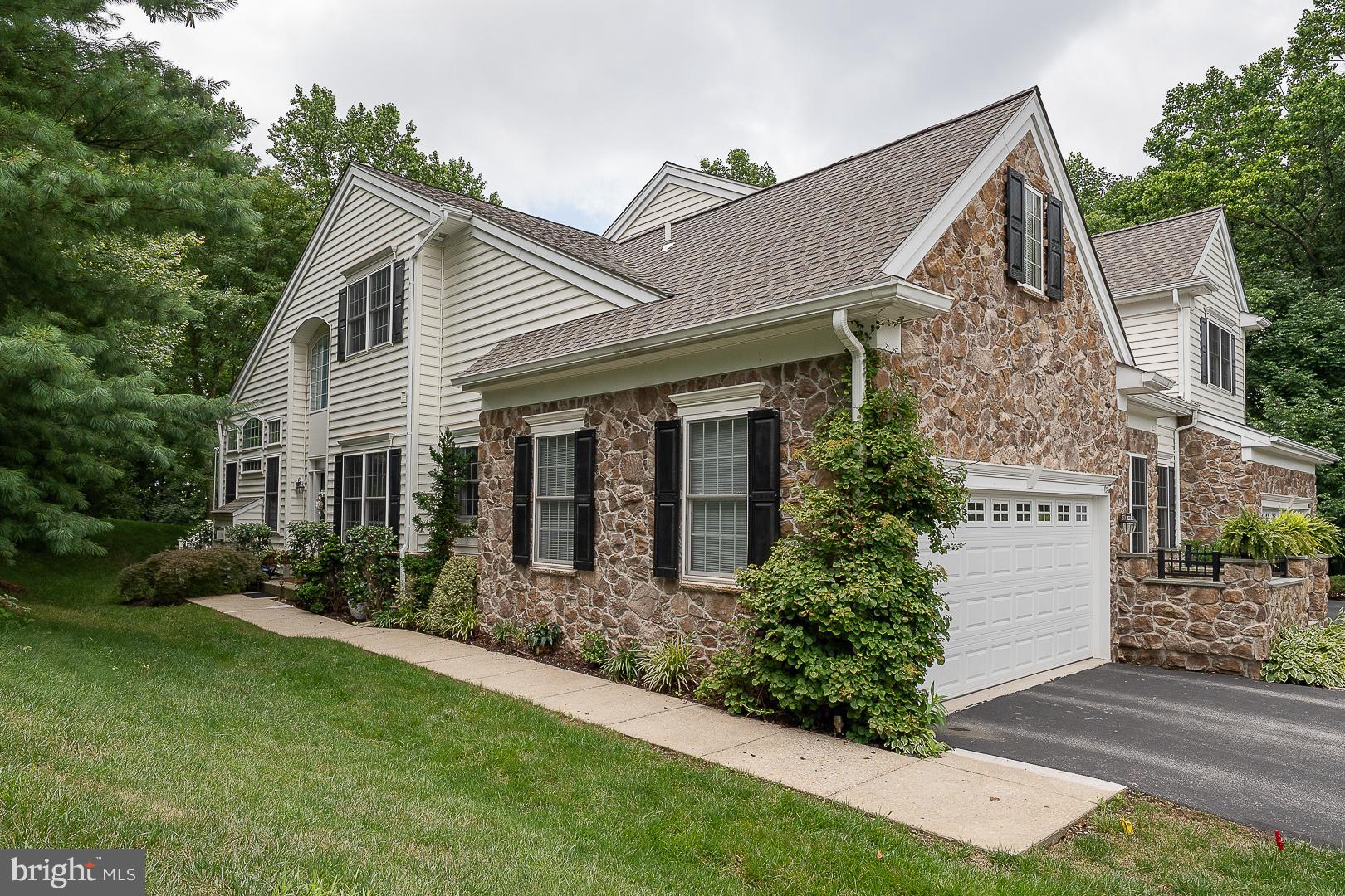 Welcome to 102 Whiteland Hills Circle—a refined stone-front townhome nestled in the sought-after “Reserve at Whiteland Hills” community, part of the award-winning West Chester School District. Perfectly situated on a premium cul-de-sac lot backing to serene woodlands, open space, and the community’s scenic walking trail, this elegant 3 Bedroom, 2 full Bath, 1 half Bath residence offers luxury, privacy, and convenience. Enjoy the benefits of a walkable lifestyle—just steps to Target and moments from the Exton train station, Main Street dining and shopping, and major commuting routes including Rt 30 Bypass and Rt 202. Designed with sophistication and comfort in mind, this home features a bright, open floor plan with soaring cathedral ceilings, abundant natural light, and a highly sought-after first floor Primary Suite. The welcoming Foyer with hardwood floors leads to a spacious Living Room adorned with a vaulted ceiling, marble-surround gas fireplace, and expansive feature windows with transoms that bathe the space in sunlight. Step through the atrium door onto a private rear deck—your personal retreat overlooking peaceful greenery and direct access to the walking trail. The formal Dining Room is enhanced with elegant crown molding and chair rail, perfect for entertaining. The Chef’s Kitchen boasts upgraded Italian porcelain flooring, a stunning custom center island, new tile backsplash, Bosch stainless steel appliances including a 5-burner gas range, and access to a charming front courtyard with stone walls—an ideal spot for morning coffee or evening relaxation. The luxurious 1st floor Primary Suite features private deck access, a walk-in closet, and a spa-inspired bath with a jetted soaking tub, stall shower with rain head, and double vanity. A stylish Powder Room and a well-appointed Laundry Room with cabinetry and drop-in sink complete the main level. Upstairs, you'll find a spacious Loft, perfect for a Home Office or Den, plus two generously sized Bedrooms with ceiling fans, connected by a Jack-and-Jill Bath with dual vanities and a tub/shower combo. The expansive Lower Level with 9’ ceilings offers endless possibilities for future living space, a gym, media room, or ample storage. Additional highlights include a 2-car garage with attic storage, central vacuum, tankless water heater, new HVAC (2018), upgraded custom lighting throughout, and abundant guest parking nearby. This exceptional home offers the rare blend of upscale living, modern amenities, and unbeatable location. Don’t miss your opportunity to call 102 Whiteland Hills Circle your new home!