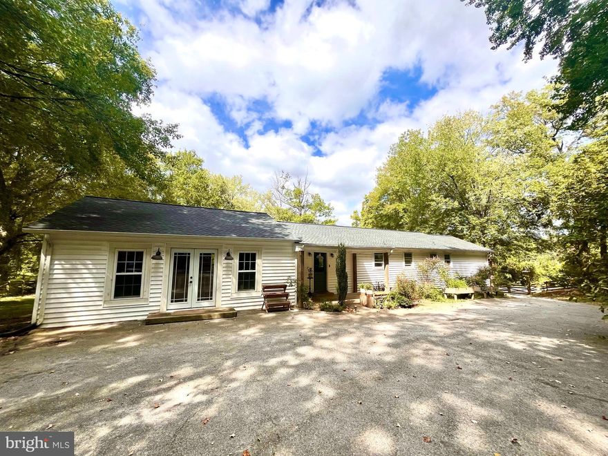 **Exceptional Opportunity! Stunning Rambler Loaded with Upgrades!** This beautiful rambler features elegant hardwood floors and a complete kitchen  with granite countertops, and stainless steel appliances. The updated bathrooms showcase stylish ceramic tiles, modern vanities, and fixtures. Enjoy abundant natural light from the new windows in the living and dining areas, along with a charming French door added in 2022. The roof and siding were also replaced in 2021, and the water heater and pressure tank were updated in 2023 for peace of mind. The spacious layout includes a large room perfect for entertaining, all situated on nearly one acre of lush land with mature shade trees. Wood fence around the house.
 Don’t miss out on this ideal location!