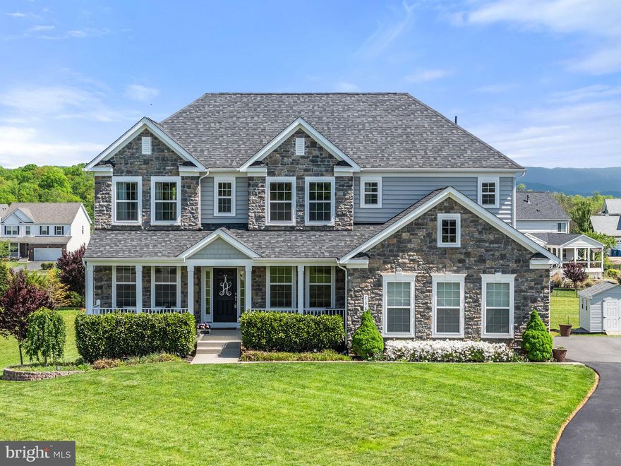 Highly sought after Berryville Glen Community!  Mountain Views  Galore!
Discover the perfect blend of comfort, luxury, and functionality in this beautifully designed Stone
Front, Side Entry Garage Home. This home boasts 5 Bedrooms, 4 full bathrooms, 9ft ceilings, hardwood flooring, a Gourmet kitchen, upgraded cabinets, granite countertops, stainless steel appliances, designer backsplash, and a spacious walk-in pantry. Morning room off the kitchen and an upper-level loft. Main-level bedroom with a full bathroom. The unfinished lower level has endless opportunities with its' walk-out basement. You can finish this for relaxation, entertainment, or multi-generational living. The nicely sized laundry room includes a laundry sink. Open-concept layout connects the kitchen seamlessly with the expansive family room, the sun-drenched morning room, and the inviting dining area ideal for hosting gatherings or enjoying quiet evenings at home. The second level features an expansive primary suite that has 2 walk-in closets and an oversized ensuite bathroom with a separate shower and soaking tub. There are 3 additional generous-sized bedrooms, one bedroom has an attached bath, and the other two share a Jack & Jill bath. This stunning Colonial Home has a front porch to envy with lush landscaping and a grand front and rear yard. Close to Commuter Routes and minutes to the Town of Berryville for shopping, restaurants, and more.