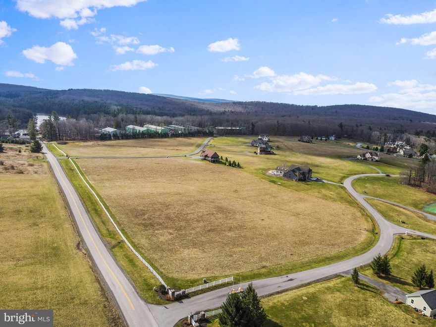 This STUNNING 2.57-acre lot, located in the highly sought-after Waterfront Greens community, is ready for you to BUILD your DREAM HOME! Public sewer hookups are in place. The well is not yet drilled and will be required to build. The community offers TONS of amenities such as a Clubhouse, Tennis Courts, Par 3 nine-hole Golf Course, NO greens fees, Miniature Golf, Sledding hill, Trails, Catch & Release Fishing Pond, and LAKE ACCESS. Plus, this lot is conveniently located to all that Deep Creek Lake has to offer such as Wisp, Youghiogheny River, Rock Climbing, White Water Rafting, Mountain Biking, Swallow Falls, Adventure Sports Center, and more!

This lot does NOT come with a boat dock/slip; however, dock slips do occasionally become available to purchase, and Deep Creek Lake State Park and Marina are very close by for boat launching.

The current owners have an informal agreement with a local farmer that hays the land on vacant lots. There is no cost or profit to the owner, but it is a win-win arrangement that allows for the satisfaction of grass-cutting obligations. If Buyer is not interested, they can certainly opt-out.