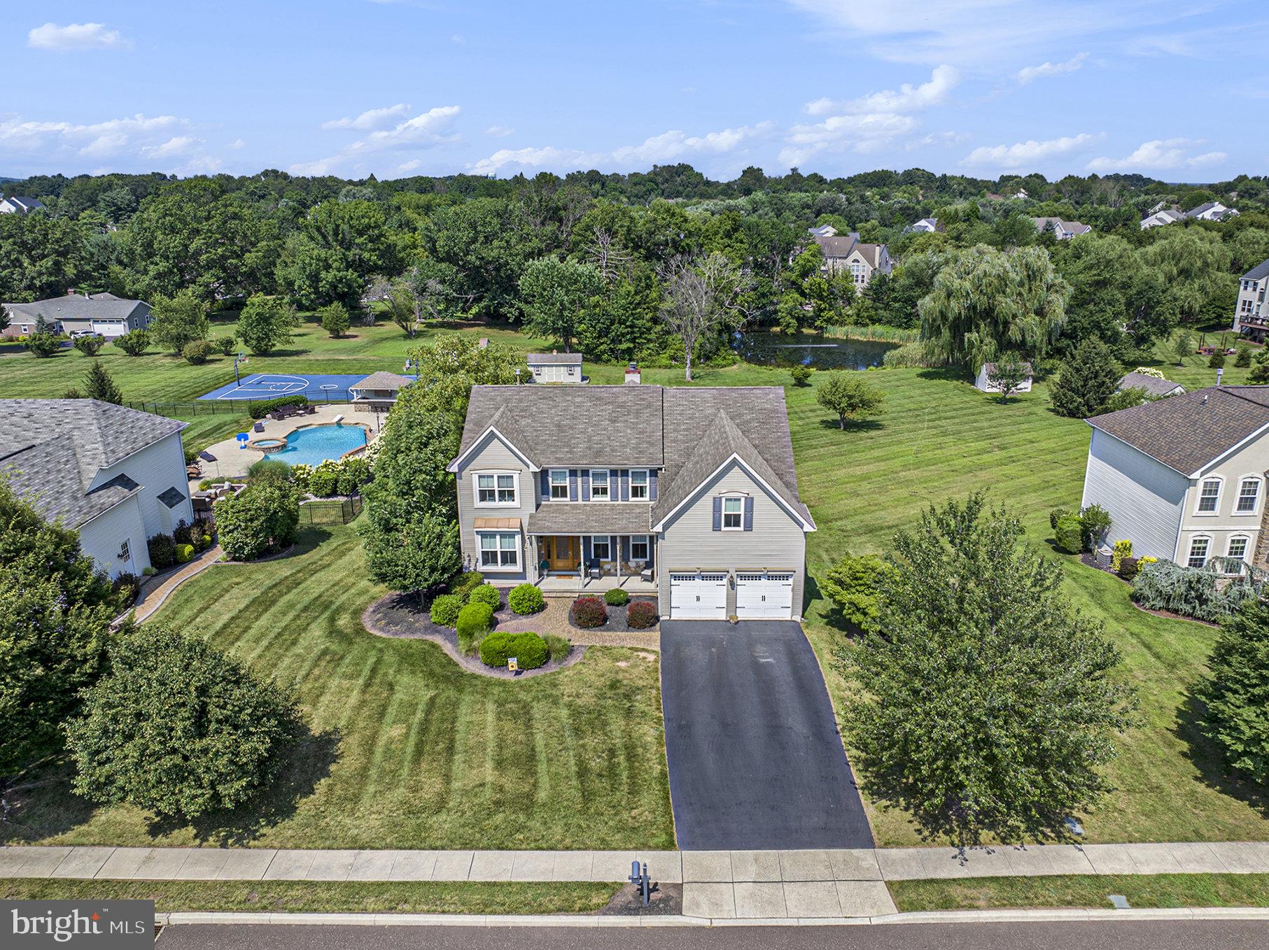 Welcome Home! Nestled in the highly desirable Spring-Ford School District, this beautifully updated home offers comfort, style, and exceptional living spaces throughout. Right from the curb, the stunning 8-foot custom front door makes a bold and tasteful first impression. Inside, you're greeted by hardwood floors that extend to dining room and kitchen, elegant white columns, and soaring ceilings. The formal living room sits to the left which is perfect for welcoming guests, while the formal dining room to the right boasts crown molding, chair rail, and a striking light fixture that completes the room. The heart of the home is in the rear of the house, where a breathtaking two-story family room showcases a floor-to-ceiling white stone fireplace. This space flows seamlessly into the updated kitchen, complete with new cabinetry, expanded island, granite countertops, undermount sink, gooseneck faucet and lots of counterspace for the cook. Step outside to a gorgeous Brazilian hardwood deck hosting a scenic view and a direct gas line for your grill, a perfect setup for outdoor activities. Also on the main floor, you'll find an office/flex room, powder room, and laundry area for added convenience. Upstairs, the open turned staircase leads to four spacious bedrooms and two full baths. The primary bedroom is a true retreat featuring an accent wall, sitting area, and an upgraded en-suite bath with a barn-style door, seamless tile shower with bench and double vanity. The additional three bedrooms are generously sized and thoughtfully decorated. The hall bath has also been updated with a tiled tub surround, wainscoting, tile flooring, double vanity, and crown molding for a polished finish. Need more space? Head to the sun-filled finished walk-out lower level, complete with a wet bar, gas stove for cozy winter nights, and a full bathroom with walk-in shower that is perfect for entertaining or accommodating overnight guests. As a bonus, all windows and the sliding glass door have been replaced! This home checks every box. Don’t miss your moment! Make your appointment today. ***Showings on Saturday from 12-3pm and Sunday from 12-4pm*****