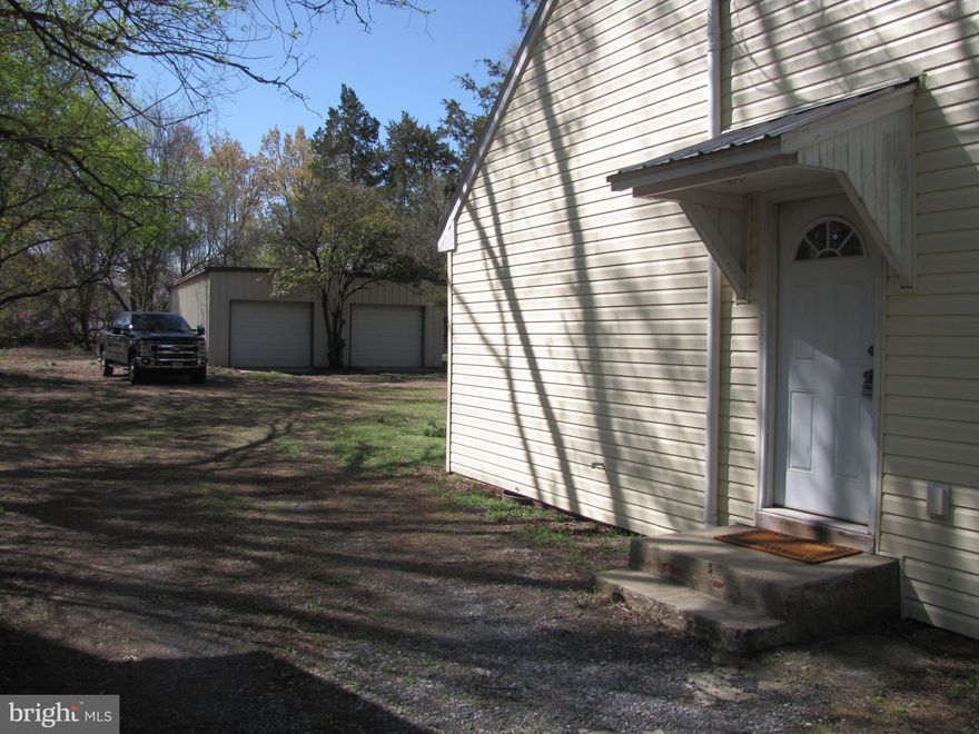 FRESHLY PAINTED AND READY TO MOVE IN- -- Large Lot! Must See if you are looking for a bit of privacy with in-Town living and a VERY Large Shop; insulated steel building with electric and 2 bays behind the house (separate meter). Great for small business owner shop or hobbyist.   Cottage style home, 2 bedrooms, 1 bath, Open Floor plan to living room. Close to waterfront for fishing or access to the Trail.  Whether its your first home, downsizing or an investment, this property is priced right for all.