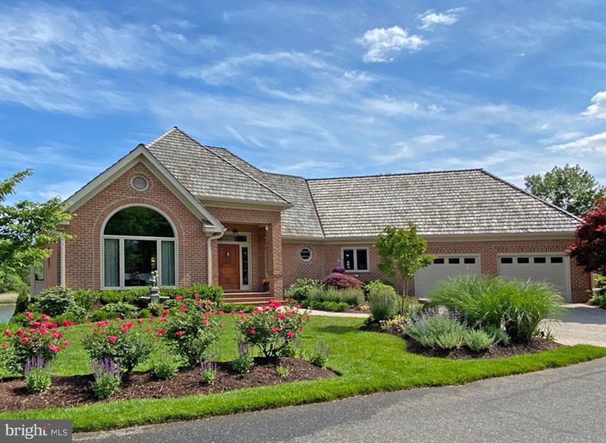 Welcome to luxury living in a gated, park-like community. This stately light-filled brick home
offers stunning views of Almshouse Creek to the South River. It was gutted down to the studs
in 2018 and completely renovated. Literally everything was replaced or refinished – all new
windows, a 50-year shake roof, geothermal HVAC, whole-house audio, smart home wiring, and
much more! The Chef’s kitchen is as functional as it is beautiful, with cherry cabinets, granite
counters, induction range, instant hot water, warming drawer, wine fridge, RO water filter, pull
out shelving and soft-close drawers. The primary bedroom offers a private deck, sumptuous
spa-like European bath that includes instant hot water, a free-standing tub, radiant floor heat,
bidet and skylights. The large cedar-lined walk-in closet offers ample space for the well-dressed
couple. Descending the open stairway to the lower level, there is a custom bar with beverage
fridge and ice maker adjoining a family room with built-in surround sound for the TV, floor heat
and a gas insert fireplace. The three large bedrooms on this level have two baths. Two of the bedrooms on the lower level have covered decks and a water view.  The storage room is enormous. The patio has beautiful views and afternoon shade. The covered porches are a delight in the rain. The garden was professionally planted and lovingly nurtured. In the attached garage there is a 50 amp outlet for electric vehicle . Best of all, ALL lawn maintenance is included in the HOA fee! That even includes leaf cleanup and shoveling snow from your driveway! South River Landing offers many other amenities, such as pool, tennis courts, private marina, kayak launch, beach, 40 acres of common space that is a manicured park, nature trails and a 24/7manned gate house to provide peace of mind. This is essentially a new home in an established neighborhood that is less than 15 minutes from downtown Annapolis.  Separately deeded 40' boat slip is available for sale - $45,000.   (Total finished square footage  is 3908 sq. ft. + 491 sq. ft. unfinished.)