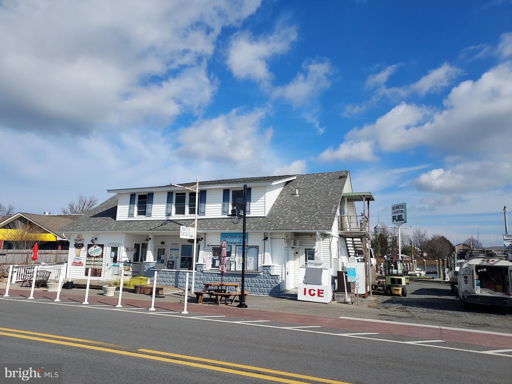 AVAILABLE FOR SALE! Locate your retail store, restaurant and/or marina right in the heart of Solomon's Island, a popular tourist area surrounded by Back Creek and the Patuxent River. Zoning regulations encourage mixed use. Please consult the Calvert County zoning ordinance for your particular use. 150 foot of Back Creek water access with a deep water pier w/10 slips perfect for marina/charter boat business or any other waterfront enterprise. Building is currently used as a Charter business, ice cream and food service operation which includes a 700 sq. foot commercial kitchen. Upper level is being converted into a 2 bedroom apartment ready to generate short term rental income in this sought after tourist destination.