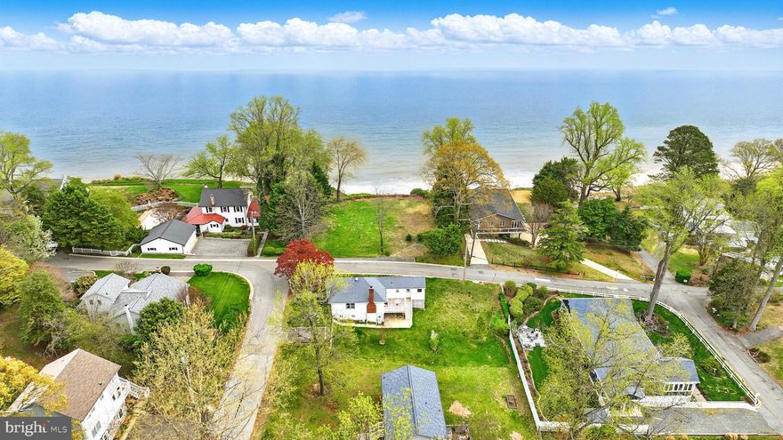 Just in time for summer!   Your very own getaway every single day.   Stunning  panoramic Chesapeake Bay views just one block off the bay and a short stroll to the sandy bay front beach.  This adorable bungalow has an open floor plan with updated kitchen open to dining and living area with fireplace.  Embrace the relaxing lifestyle this home offers with built in sauna.  Main level full bath and bedroom leading to deck.  Lower level has laundry area and awaits your design with space for rooms.   Endless options here for year round living, vacation destination or something in between.    Enjoy beach days with swimming, kayaking, looking for sharks teeth.   Marina close by for boating enthusiasts.  Check out virtual tour!  The views will not go away as the lot between the bay and this home won’t be built on.