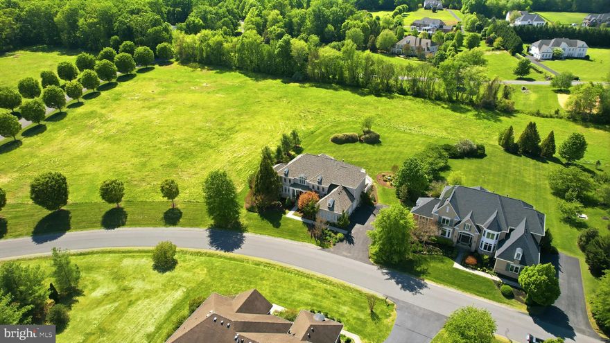 Set in prestigious Red Cedar West, this north facing, four-side brick exceptional Gulick-built Winthrop Manor combines grand scale, timeless architecture, and a rare sense of privacy. Sited on a .73-acre lot surrounded by HOA conservancy land, the property offers an openness and serenity that is increasingly hard to find. With over 8,000 finished square feet, 6 bedrooms, 5 full baths, 2 half baths, and more than $200,000 in recent improvements, showcasing timeless elegance thats designed for both everyday living and elevated entertaining without sacrificing comfort. The exterior is equally impressive with an oversized three-car garage with extra height and a flat, manicured lawn perfectly suited for a future pool. 

Inside, the home opens with a dramatic two-story foyer and sweeping curved staircase that set the tone for the elegant formal spaces beyond. The main level features a gracious living room, a refined dining room with a butler’s pantry, and a striking two-story conservatory. The family room features a gas fireplace and is framed by a wall of windows overlooking the private rear setting, creating a layout that works beautifully for both large gatherings and everyday living. A private home office offers the ideal work-from-home space. Fresh paint, updated flooring, and refined finishes throughout deliver a polished, move-in-ready feel.


The updated gourmet kitchen—truly the heart of the home—seamlessly blends timeless design with exceptional functionality. It features abundant white cabinetry, quartz countertops, a classic subway tile backsplash, and premium stainless steel appliances, including a Sub-Zero refrigerator, double wall ovens, and a professional-grade gas cooktop. A large center quartz island anchors the space, complemented by a serving station—ideal as a coffee or beverage bar—and a separate built-in planning desk. Expansive counter space provides the perfect setting for both everyday meal prep and effortless entertaining.


The kitchen flows beautifully into the breakfast area and sunroom, with direct access to the expansive deck—creating an ideal indoor-outdoor living experience. A convenient rear staircase, along with a  mudroom, laundry room, and two half baths, completes the thoughtfully designed main level.

The upper level offers five generously sized bedrooms, each with walk-in closets. The luxurious primary suite serves as a private retreat, complete with a sitting room and fireplace, dual walk-in closets, and a beautifully updated spa-inspired bath featuring a freestanding tub, frameless shower, and double vanity. Two of the secondary bedrooms include private en-suite baths, while the remaining bedrooms share a well-appointed Jack-and-Jill bath with double sink vanity.


The expansive walk-up lower level features a custom wet bar, multiple recreation areas, a media room, gym, and flexible spaces to suit a variety of needs. An additional bedroom and full bath, along with a third fireplace, enhance comfort and functionality, while abundant storage keeps everything organized. Ideal for entertaining, multigenerational living, fitness, hobbies, or private guest accommodations, this level offers exceptional versatility.

Beyond the home itself, the location adds yet another layer of appeal. Nestled within the sought-after enclave of Red Cedar West—known for its larger estate homes and distinctive setting—this property offers both privacy and convenience. Just minutes from downtown Leesburg, the Dulles Greenway, Dulles Airport, shopping, dining, nearby wineries and breweries, and Loudoun Country Day School, the setting is truly exceptional.
Recent Updates & Improvements
Recent improvements include a new roof (2025), HVAC and furnace (2026), hot water heater (2021), and new carpet throughout the upper level (2026), along with fresh interior paint and updated LED lighting and fixtures throughout the home.