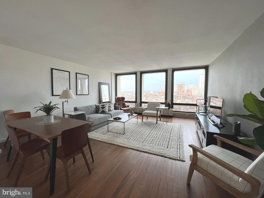 Beautifully updated studio with Center City sunset views at Society Hill Towers! Enter through a foyer with large coat closet into the open great room boasting ample space for everyday living and entertaining and a wall of floor-to-ceiling windows showcasing spectacular sunset views. Adjacent is the fully updated kitchen with white shaker cabinetry, granite countertops, stylish tile backsplash, and stainless steel appliances. There is a dressing area with excellent closet space that leads to the upgraded bathroom with sleek modern vanity, tub shower, and marble-like tile floor. There are new vinyl floors throughout and updated lighting and fixtures. Residents of Society Hill Towers enjoy a 24-hour doorman and all utilities plus basic cable. Access to the building's outdoor seasonal pool, fitness room, storage lockers, and parking in the building's underground garage are available for an additional fee. Also, there is an on-site Philly Car Share, a coin operated laundry room in the basement, and a shopping plaza on site with a market, dry cleaner, beauty salon, and one of Philly's most acclaimed restaurants, Zahav.