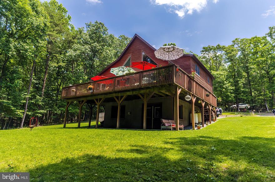 Outstanding  Cedar Chalet on 4.36 acres with 2750 sq.ft. This home features 3 levels of living space. Has 4 Bedrooms  and 4 Baths. including  a Master Suite  on the upper level. This home has 3 gas fireplaces and is dual zoned  HVAC Unit..  The Master Suite has a loft sitting area, Jacuzzi 5X6 tub, Double vanity, Slate walk-in double shower, Gas glass fireplace, Balcony and wood floors. The main level living area has the Great Room with Dining area and Kitchen with  island.  2 bedrooms one is a Master bedroom with master bath. The main bath has slate flooring.  The Kitchen features granite counter tops  and island with granite , Cherry wood cabinets,  wood flooring, stainless steel appliances,  with Microwave /Convention Oven,. Main level has Gas glass fireplace and  all wood floors.  Screened  Porch and Deck off the main level.  The screened porch has 2 ceiling fans with lights. Lower level features the family room, kitchenette with commercial refrigerator, Gas fireplace,  Wet bar, Bedroom #4 and Bath #4, Laundry Room , Exercise room and 2 Utility closets. Double doors go out to ground level on to concrete patio. There is also a detached garage and  shed. There is a fenced area for dog or pets. This lovely home has all you need and more. This is a very energy efficient home. Utilities include electric and propane gas.  Has on demand hot water. Home has well water and septic. Located in the beautiful mountains of Great Cacapon, WV.  Just a short distance from the historic and famous Berkeley Springs.  WV.  Call today for a tour.