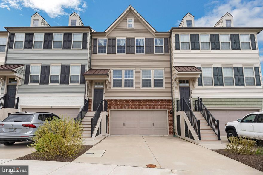 Welcome to this meticulously designed three-story townhome, nestled in the highly desirable Tall Oaks Community. This residence offers a thoughtfully planned layout, starting with the first floor, which features an expansive garage, a versatile basement space, and a walk-out patio, perfect for enjoying serene outdoor moments.

The second floor is the heart of the home, showcasing a beautiful open-concept living room and a gourmet kitchen. The kitchen is equipped with elegant granite countertops, a stunning custom backsplash, and brand-new KitchenAid Energy Star appliances. Enhanced by over and under cabinet lighting, new fixtures, and a spacious island complete with built-in wine racks, this kitchen is ideal for any culinary enthusiast. The wine racks within the island provide convenient storage and display for your favorite bottles, adding both functionality and a touch of sophistication. Adjacent to the kitchen, the generous deck provides an inviting space for barbecuing and outdoor entertaining.

The third floor hosts three well-appointed bedrooms, including the main bedroom suite, a sanctuary featuring double vanities, a large glass-enclosed shower, and an expansive walk-in closet. Two additional bedrooms and a hall bath complete this level, along with a convenient laundry area.

Additional upgrades include a 10' x 20' maintenance-free deck with a privacy fence, a powder room on the first floor, a box ceiling in the owner's bedroom, and luxury wood flooring throughout the second floor. The bathrooms are adorned with white cabinets, granite countertops, and ceramic tile, enhancing the home's luxurious feel.

This intimate collection of thoughtfully designed luxury townhouses provides generous living space, with easy access to local amenities such as dining, retail, and services. The property is conveniently located near major commuting corridors, offering seamless access to all that Bucks County has to offer. Freshly painted and move-in ready, this home invites you to settle in and enjoy the perfect blend of comfort and sophistication.