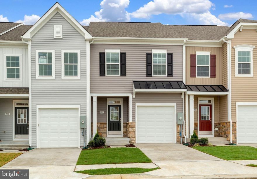 Beautifully appointed garage townhome located in Freedom Manor. Built in 2022 this home features close to 2400 finished square feet on 3 levels and is ideally located on one of the best lots in the neighborhood! No more hauling groceries up the stairs as this floor plan offers that highly desirable main level entry making this the perfect home for easy living. Just a few of the interior upgrades include warm luxury vinyl plank flooring spanning the main level and upstairs landing. Oak stairs connecting the levels for that clean, modern look. In the kitchen you will be pleased to see that no expense was spared! Upgrades to the space include soft close cabinets with contemporary hardware, complimentary backsplash, under cabinet lighting, premium stainless appliances, apron sink and quartz counters. Please note this home features the upgraded alternate main level floor plan that shifted the kitchen location and added more cabinetry and counter top space. Head upstairs and envision waking up every morning to that peaceful tree lined view from your owners suite complete with tray ceiling, siting area and spacious closet. Owners bath features shower with large scale tile and frameless glass door, quartz counters and upgraded fixtures. Two additional oversized guest beds with cathedral ceilings, shared bath and laundry room finish off the upper level. Downstairs is your finished walk out basement with full sized windows, full bath and more room to relax or use as a fourth bedroom. Out back you will find a large composite deck creating the perfect setting to fire up the grill and enjoy entertaining family and friends. Plenty of visitor parking and close to shopping, dining and commuter routes. This home checks all the boxes, schedule your showing today!