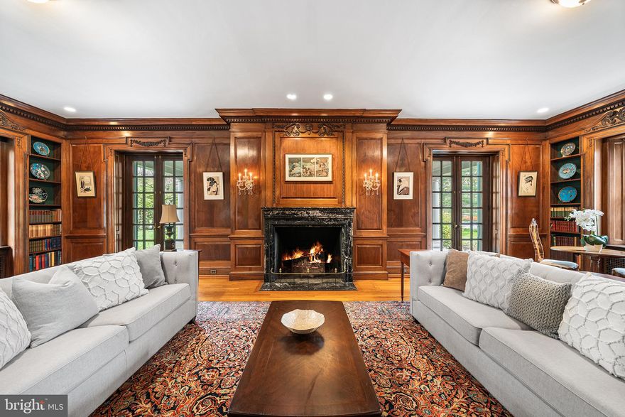 6600 Wissachickon Avenue in the West Mount Airy neighborhood of Philadelphia is a once in a lifetime opportunity to own a home designed by famed gilded age architect, Horace Trumbauer for textile magnate, Joseph Wasserman. The Trumbauer-Wasserman house (1909) is one of the few remaining homes with preserved original details in this country designed by Trumbauer, who is best known for his design of the Philadelphia Art Museum. This truly special home is situated on just under 1.3 acres of land, located steps from Wissahickon Valley Park and offers over 8,000 square feet of beautifully crafted living space, including seven bedrooms and five bathrooms plus an on-site freestanding carriage house. This home features a main floor designed by Trumbauer as the ultimate entertainment space with an extraordinary reception room, dining room with “hidden” cabinets in its wooden paneling, two accessible outdoor entertaining spaces, an intimate sitting room, formal living room, and spacious kitchen with a large pantry. Notably, the formal living room features floor-to-ceiling original book-matched English walnut paneling that was handcrafted in London, later shipped to the United States, and delicately reassembled in the home, accented by the original green marble fireplace. There are six original fireplaces inside the home and one outdoor fireplace for the rear patio space. The kitchen has been sensitively modernized with custom cabinetry, including a subway-tile backsplash accented by a handcrafted mosaic tile, seamlessly built-in Sub-Zero refrigerator, checkered marble floors, a stunning Lacanche range, handmade and imported from France, plus an oversized island and a large pantry. The second floor features four bedrooms, including a primary suite with gorgeous original fireplace, a vintage wall safe, two walk-in closets, a fully renovated bathroom with a focus on period-appropriate details and a dressing room with another stunning, original fireplace. A traditional “sleeping porch” is located adjacent to the primary suite. There is also a spacious den on the second floor that could comfortably function as a bedroom space if desired. The third floor features a casual living space, two bedrooms, another full-size bathroom with a refinished clawfoot tub and a stunning built-in wardrobe area. The Wasserman family were in the textile business and this handcrafted wardrobe space was likely an area used to carefully store the family’s personal collection of household textiles. Outside, there is a large carriage house with fully functional one-bedroom apartment space and a four-car garage for your vehicles. The main house is surrounded by the beautiful evolution of a French-inspired garden including multiple outdoor living spaces and two mature Japanese maple trees that thoughtfully define the main entrance to this remarkable home. This home is a truly stunning piece of American history that you likely won’t find again. ***This home is located less than 10 miles away from Center City Philadelphia and the Amtrak to New York City and less than 15 miles from the Philadelphia International Airport for easy travel to any destination. ***