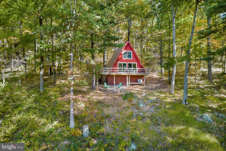 1 bed, 1 bath A-frame retreat nestled in the heart of the Shenandoah Valley. This turn-key, active short-term rental, with an average occupancy rate of 72.2%, offers a unique blend of privacy, character, and strong income potential. Inside, enjoy a bright, open living space with vaulted ceilings, warm wood accents, a cozy wood stove, and a recently remodeled kitchen featuring modern finishes and a coffee/tea bar. The loft bedroom provides a sweet escape with beautiful mountain views.

The home features numerous recent upgrades, including a kitchen with quartz countertops (2022), new flooring (2022), a mini split system (2022), a recently stained deck (2022), a new hot water heater (2023), a new well (2024), and crawl space encapsulation completed in 2025.

Step outside to a spacious deck and fire-pit area, perfect for relaxing and taking in sweeping views of mountain, river, and valley scenery. Located in a private, gated community with access to nearby hiking trails, waterfalls, and outdoor recreation. Just 19 minutes to Shenandoah River State Park and 30 minutes to Skyline Caverns and Shenandoah National Park. Ideal as a private retreat, short-term rental, or investment property.