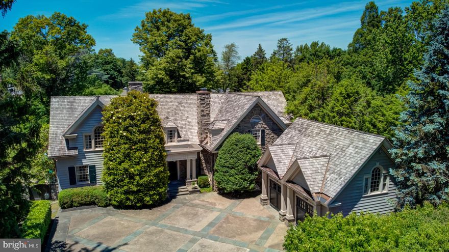 Nestled in the heart of Old Wyndmoor, yet only blocks from the center of Chestnut Hill on picturesque Spring Lane, sits this gorgeous 5 bedroom, 5 full and 1 half bath gem. Just a short stroll to Chestnut Hill, the shopping and dining on the Avenue, and Gravers Lane Station. This is an excellent spot for buyers who want all the access and amenities of Chestnut Hill without being in Philadelphia County. Follow the enchanting storybook entrance into the lovely courtyard past the mature, flowering dogwood trees. Through the front door, you are met by the large center entrance hall with double sided fireplace. To the left is the formal living room, with large bay window overlooking the serene in-ground pool and gardens, and double doors to the lovely, rear garden. The dining room is perfect for large family gatherings. A butler's pantry with custom cabinetry, wet bar and ice maker lead to the bright chef's kitchen with large center island, honed granite countertops, custom cabinetry, radiant floors, professional Viking range, Sub-Zero refrigerator and intimate breakfast area. The cozy den just steps from the kitchen area features a wood-burning fireplace, tray ceiling, custom built-ins and French doors to the gardens. Upstairs, the expansive master suite is flooded with light and offers dual baths and walk-in closets, and a small office. Three additional bedrooms are located on this floor, one ensuite and two with hall bath access; large laundry room and a rear staircase. The fifth bedroom suite is situated over the large detached 2-car garage, just removed from the house, and is perfect for out of town guests or as an au-pair suite. The large, secluded flagstone terrace overlooks the rear garden, and the pool is an absolute oasis. The grounds are superb, with beautiful gardens and outdoor spaces. This gem is the one you've been waiting for - a superlative Wyndmoor retreat just steps from Chestnut Hill - walk to the shops and restaurants along the Avenue, the Gravers train station for an easy commute to Center City Philadelphia, and to the Fairmount Park trail system. Simply the best! Contact us for a private virtual tour.